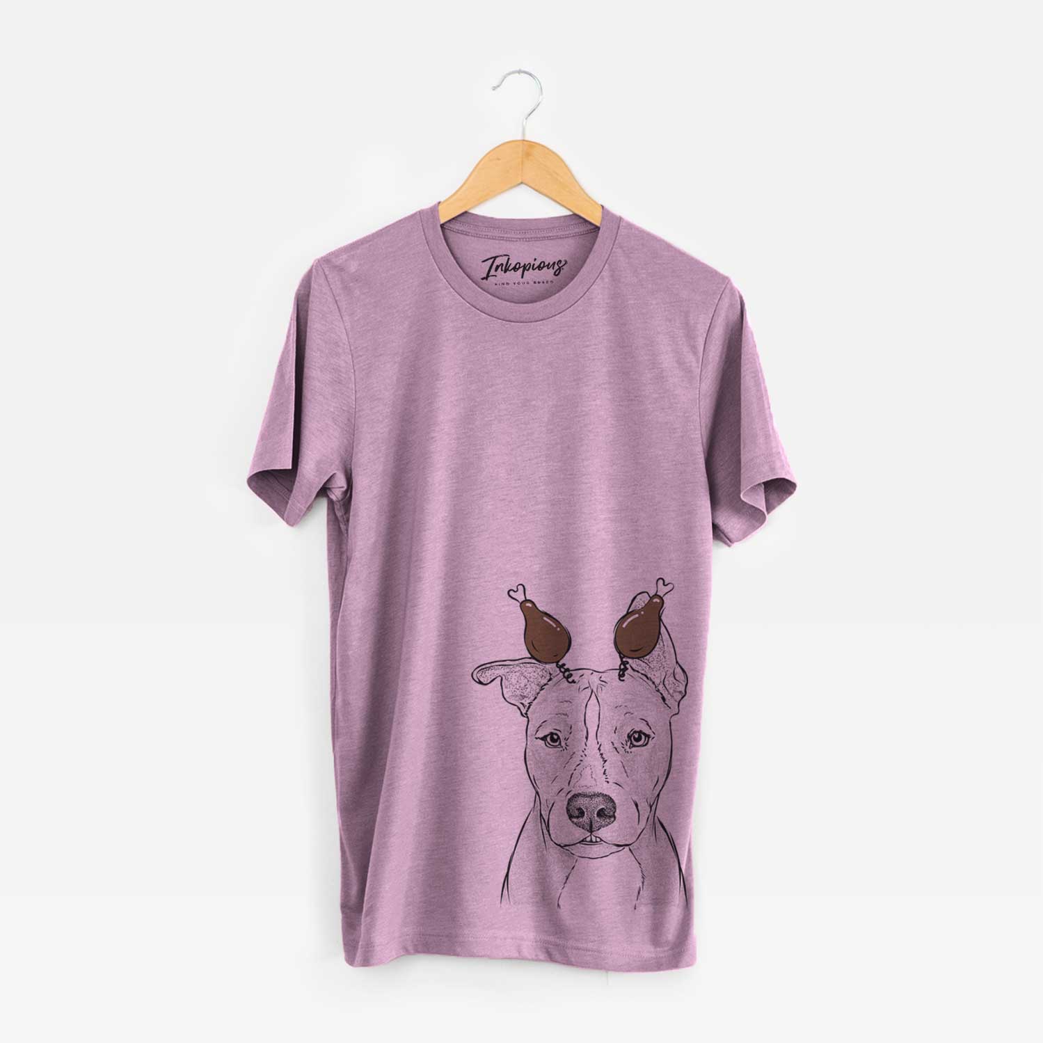 Hand-drawn sketch of Kisses the Pitbull with a Thanksgiving turkey headpiece on an Orchid Unisex crewneck