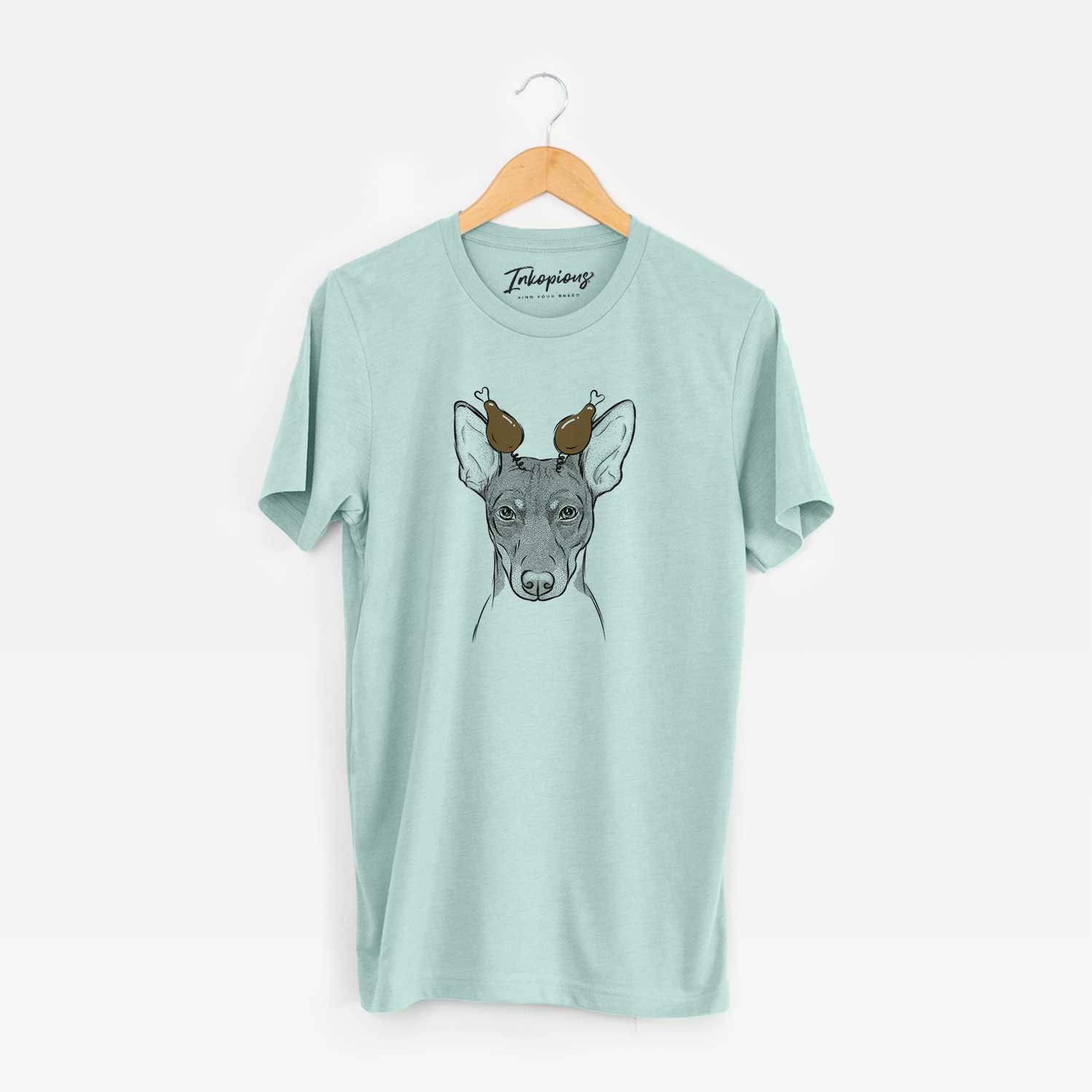Hand-drawn sketch of Knox the Rat Terrier with a Thanksgiving turkey headpiece on a Heather Sage Unisex crewneck