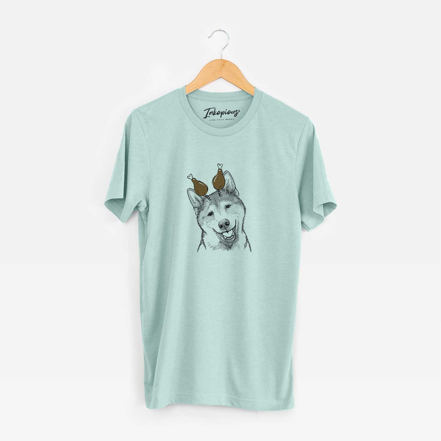 Hand-drawn sketch of Koby the Shiba Inu with a Thanksgiving turkey headpiece on a Heather Sage Unisex crewneck