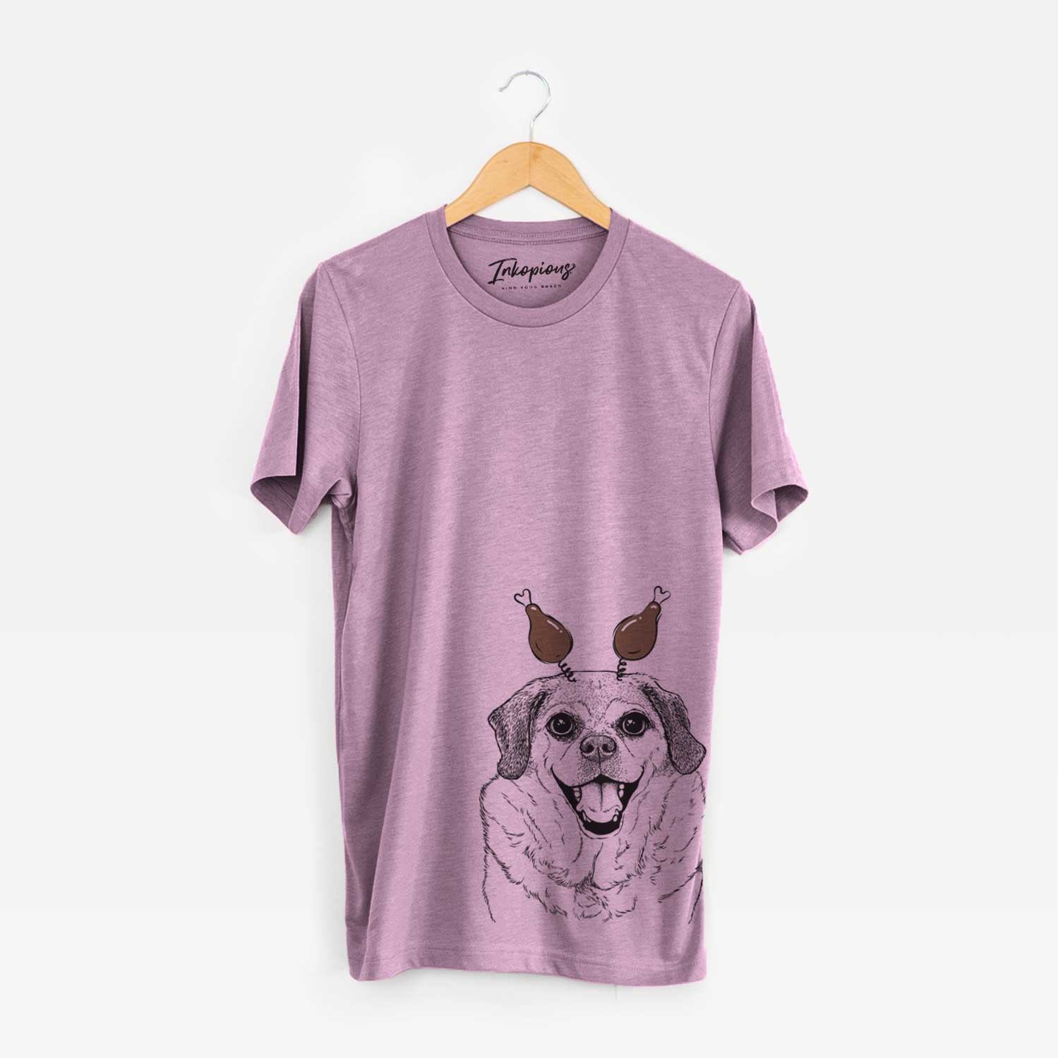 Hand-drawn sketch of Little Man the Puggle with a Thanksgiving turkey headpiece on an Orchid Unisex crewneck