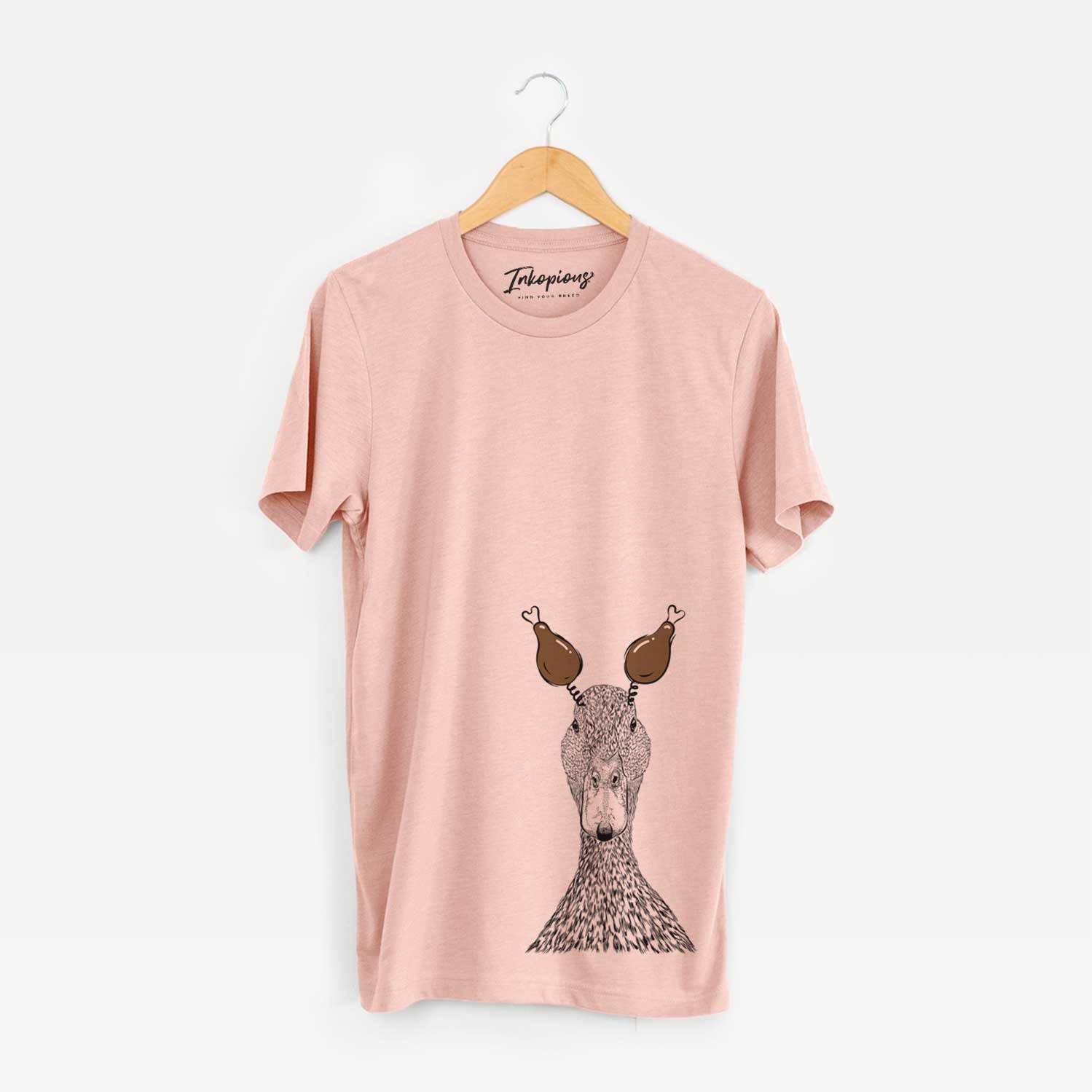 Hand-drawn sketch of Marge the Mallard Duck with a Thanksgiving turkey headpiece on a Peach Unisex crewneck