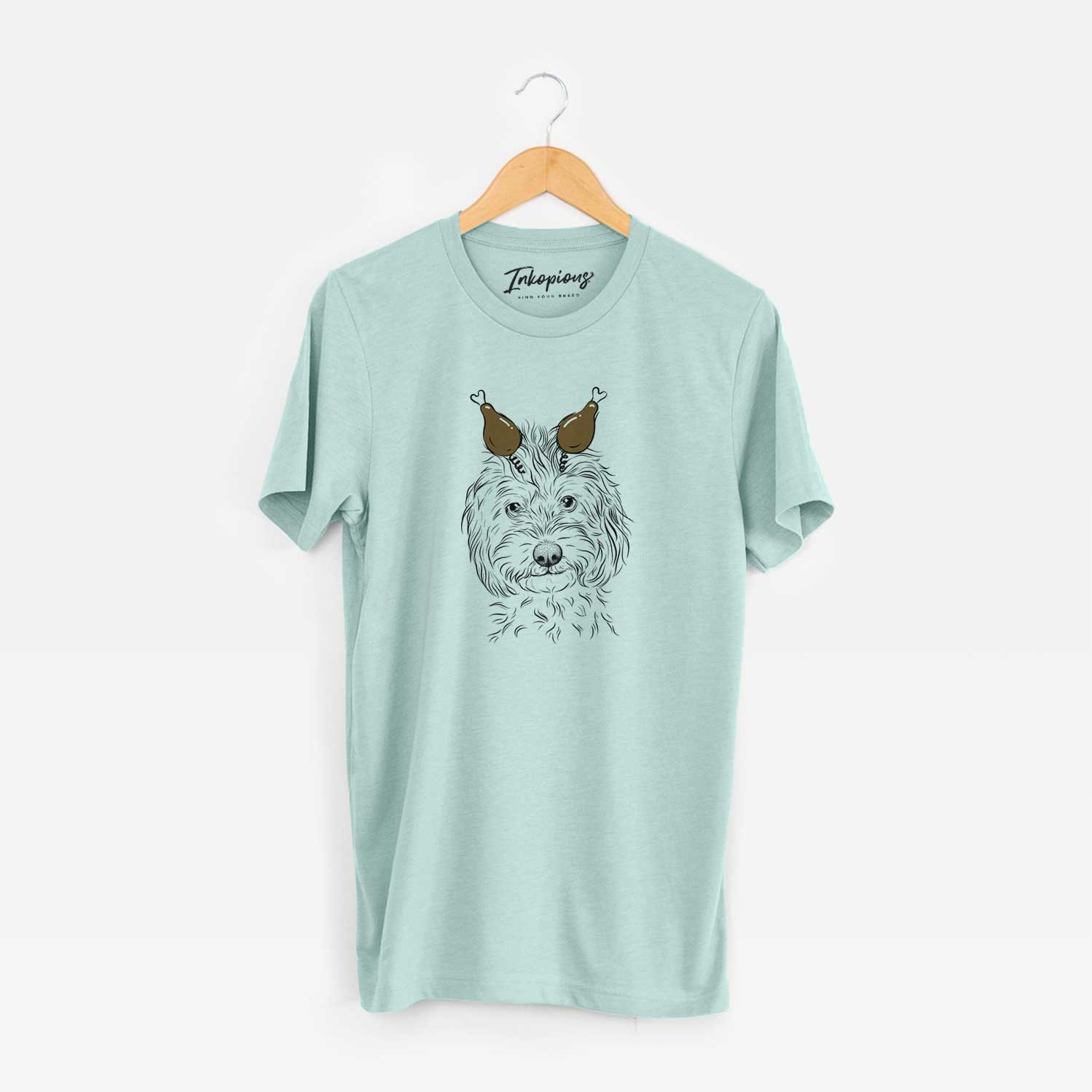 Hand-drawn sketch of Mason the Cavapoo with a Thanksgiving turkey headpiece on a Heather Sage Unisex crewneck