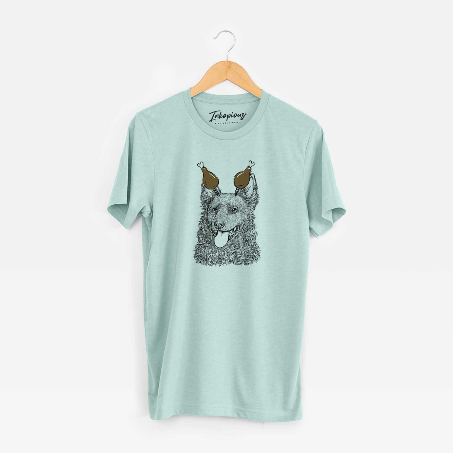 Hand-drawn sketch of Maximo the Mudi with a Thanksgiving turkey headpiece on a Heather Sage Unisex crewneck