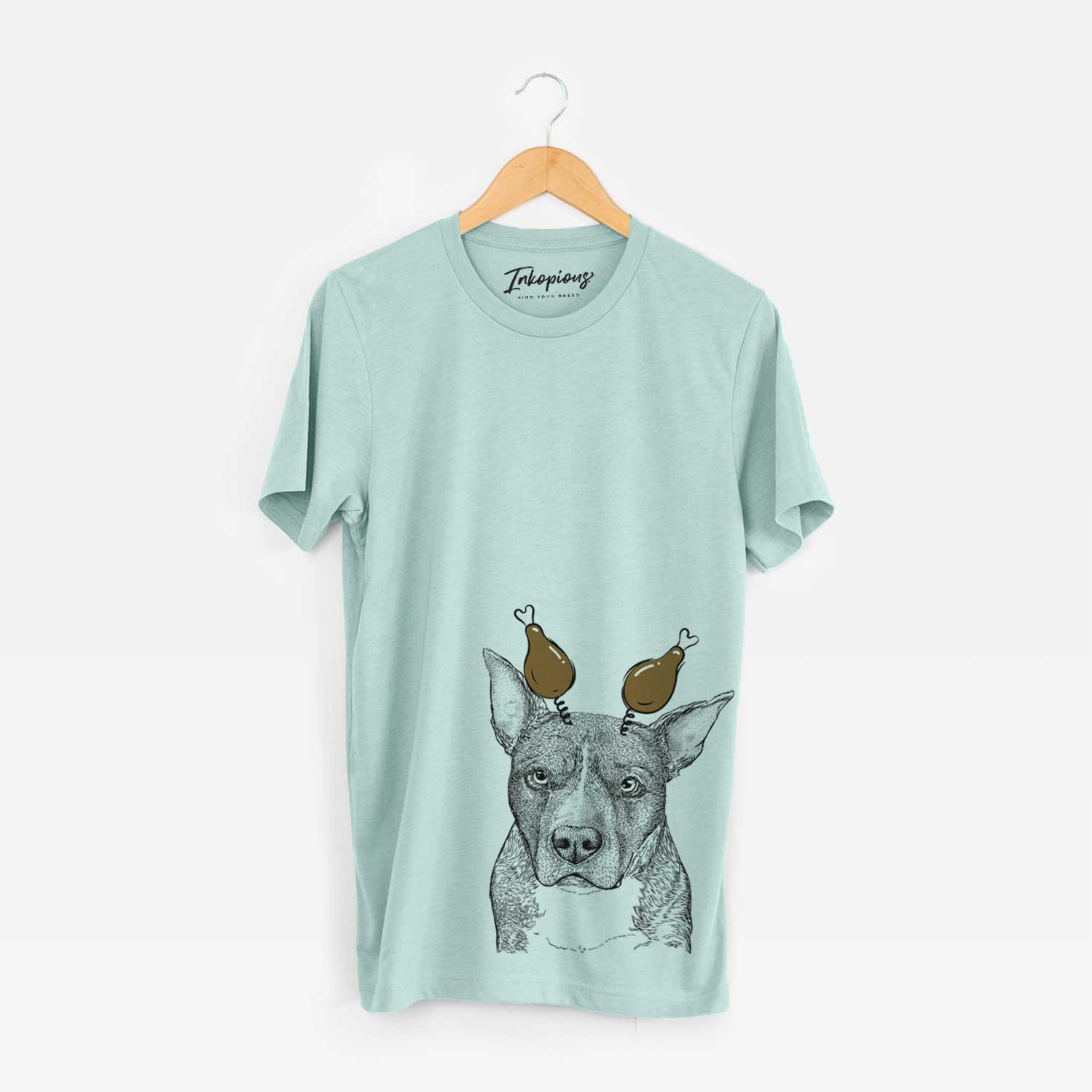Hand-drawn sketch of Mercy the Pitbull with a Thanksgiving turkey headpiece on a Heather Sage Unisex crewneck