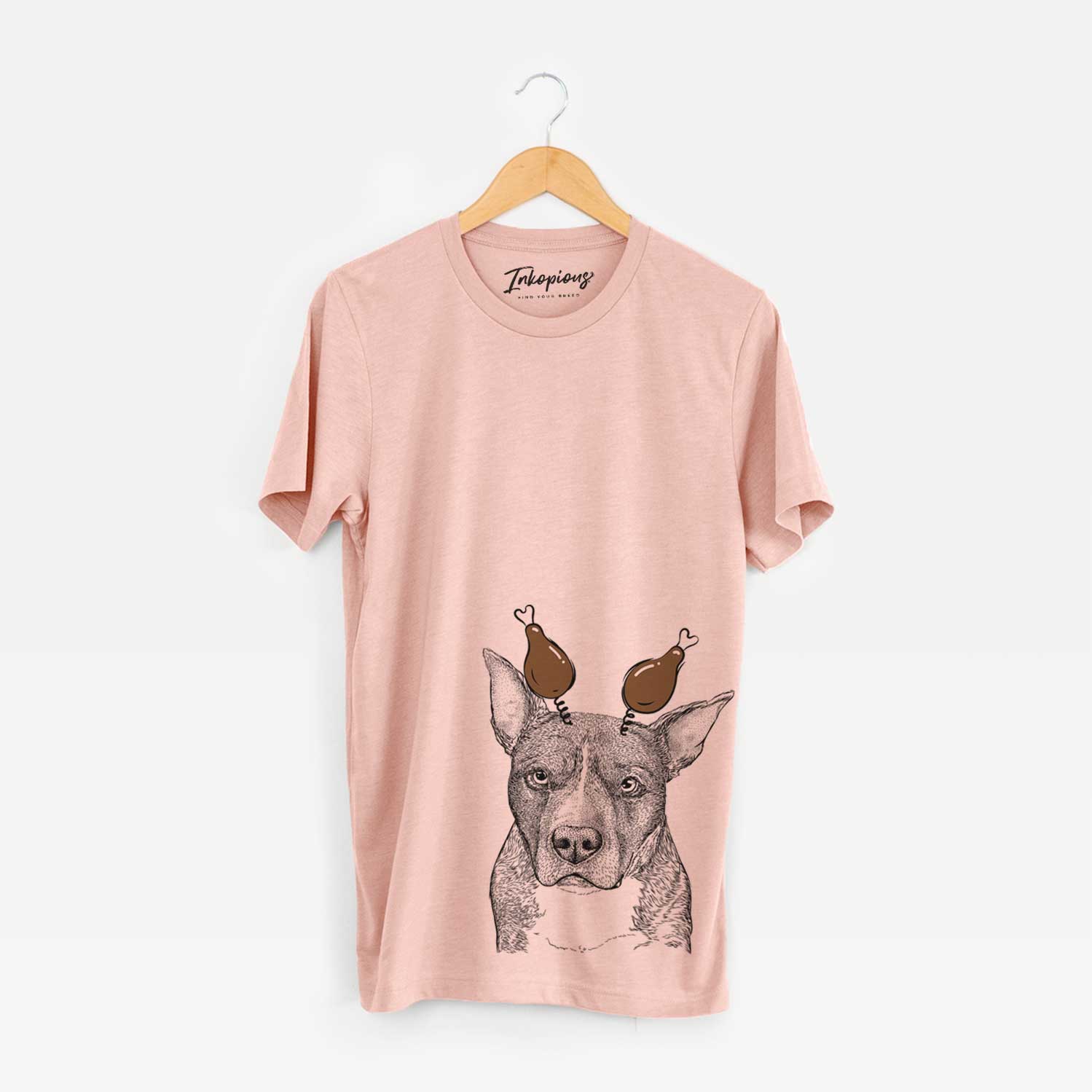 Hand-drawn sketch of Mercy the Pitbull with a Thanksgiving turkey headpiece on a Peach Unisex crewneck