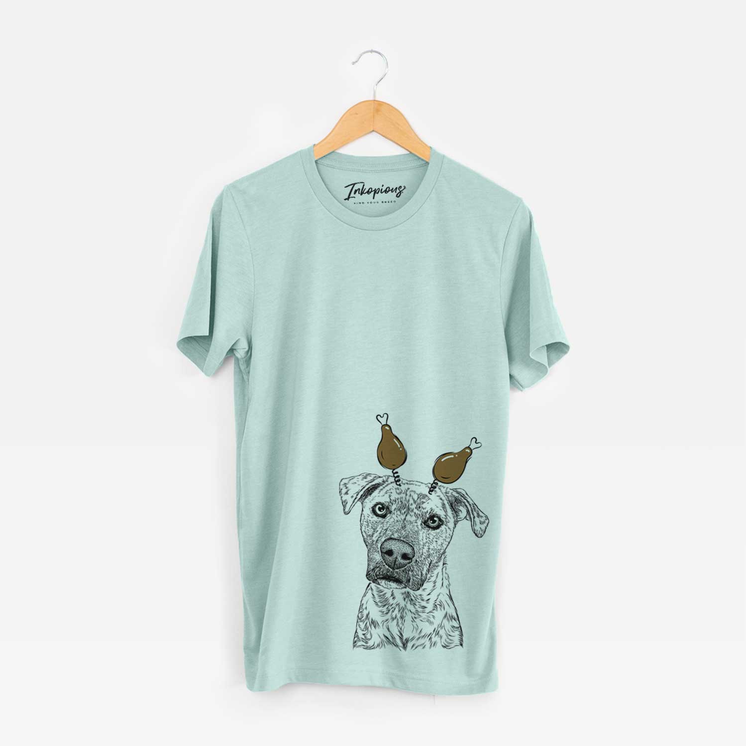 Hand-drawn sketch of Monster Baby the Pitbull Mix with a Thanksgiving turkey headpiece on a Heather Sage Unisex crewneck