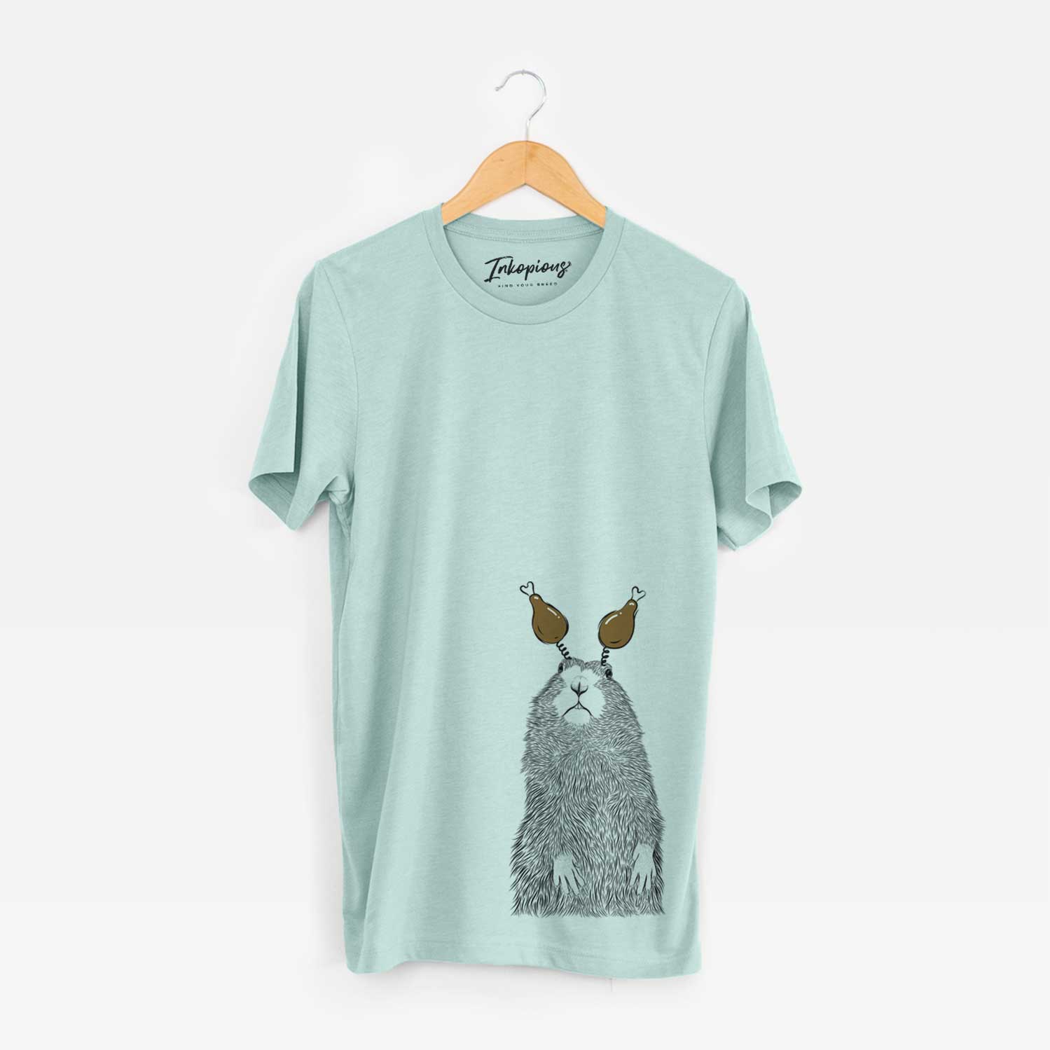Hand-drawn sketch of Mr. Otis the Prairie Dog with a Thanksgiving turkey headpiece on a Heather Sage Unisex crewneck