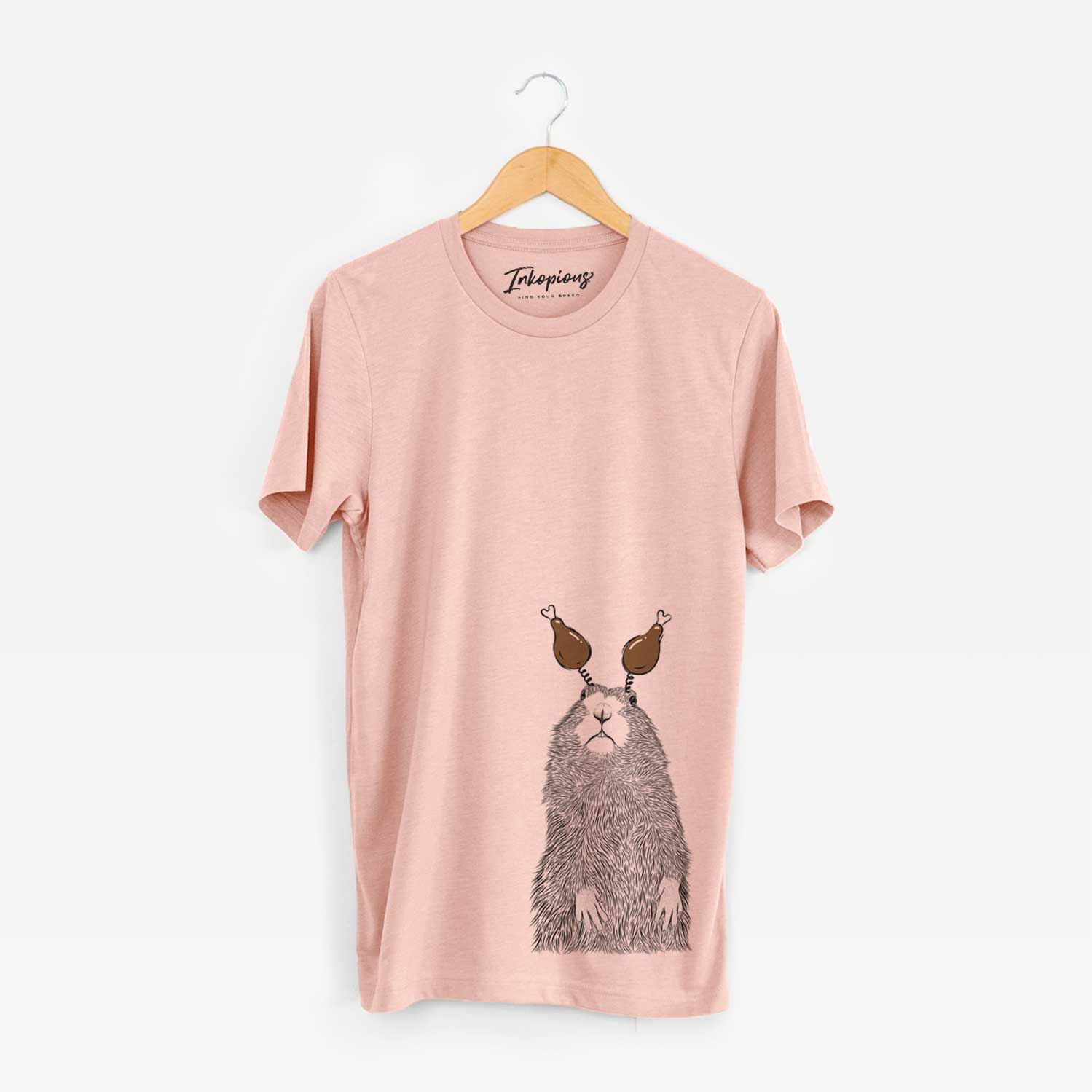 Hand-drawn sketch of Mr. Otis the Prairie Dog with a Thanksgiving turkey headpiece on a Peach Unisex crewneck