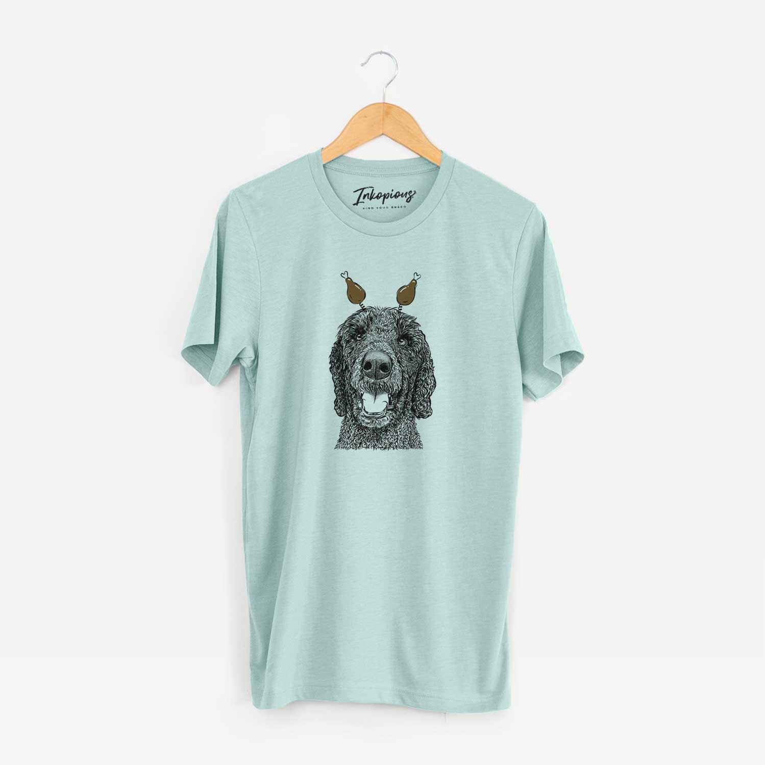 Hand-drawn sketch of Obi James the Goldendoodle with a Thanksgiving turkey headpiece on a Heather Sage Unisex crewneck