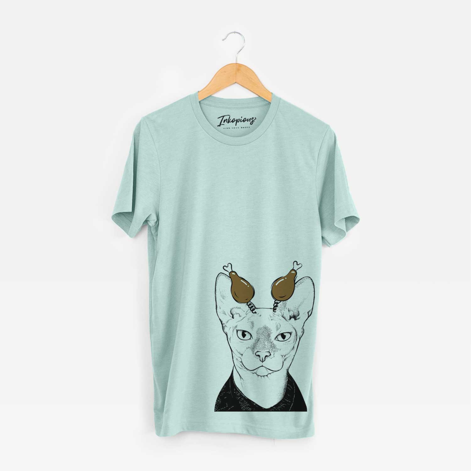 Hand-drawn sketch of Oliver Watson the Sphynx Cat with a Thanksgiving turkey headpiece on a Heather Sage Unisex crewneck