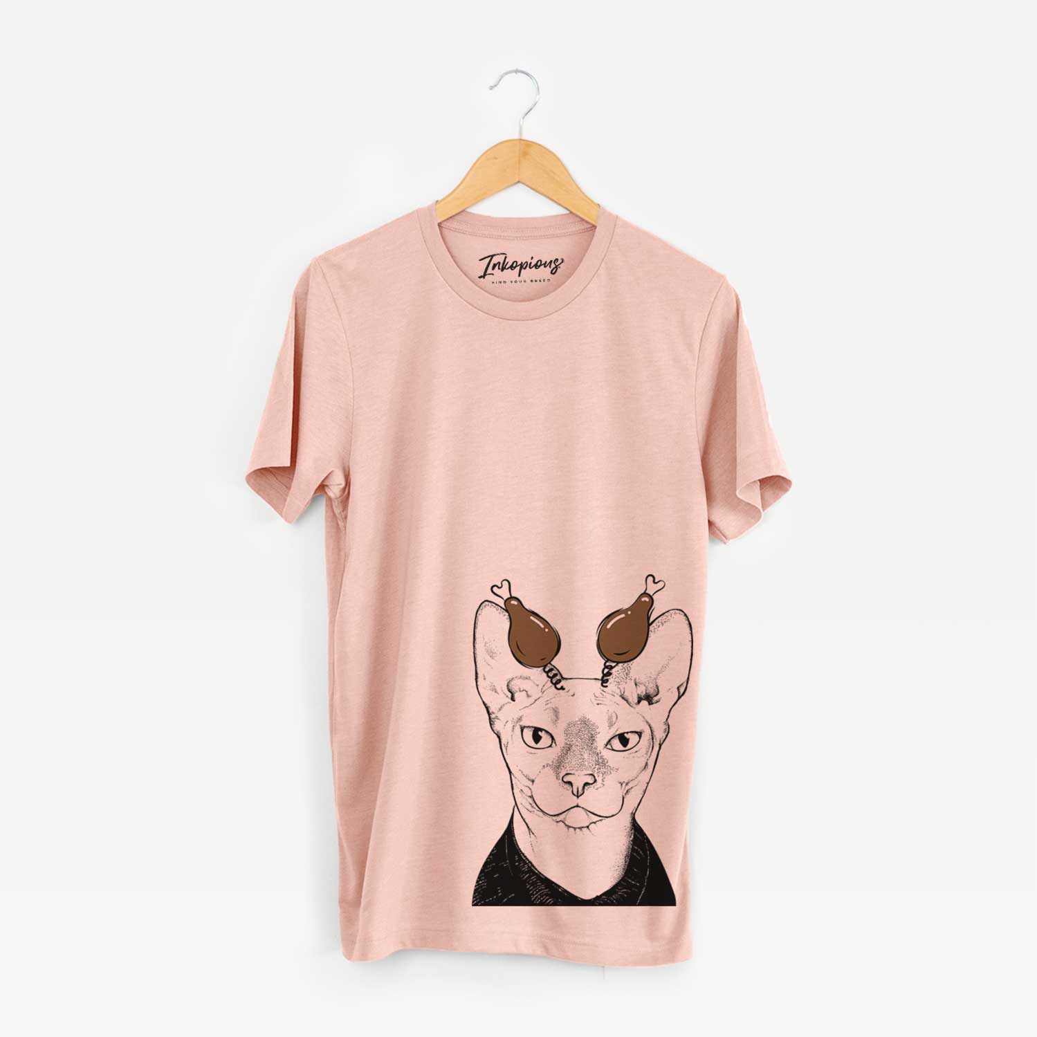 Hand-drawn sketch of Oliver Watson the Sphynx Cat with a Thanksgiving turkey headpiece on a Peach Unisex crewneck