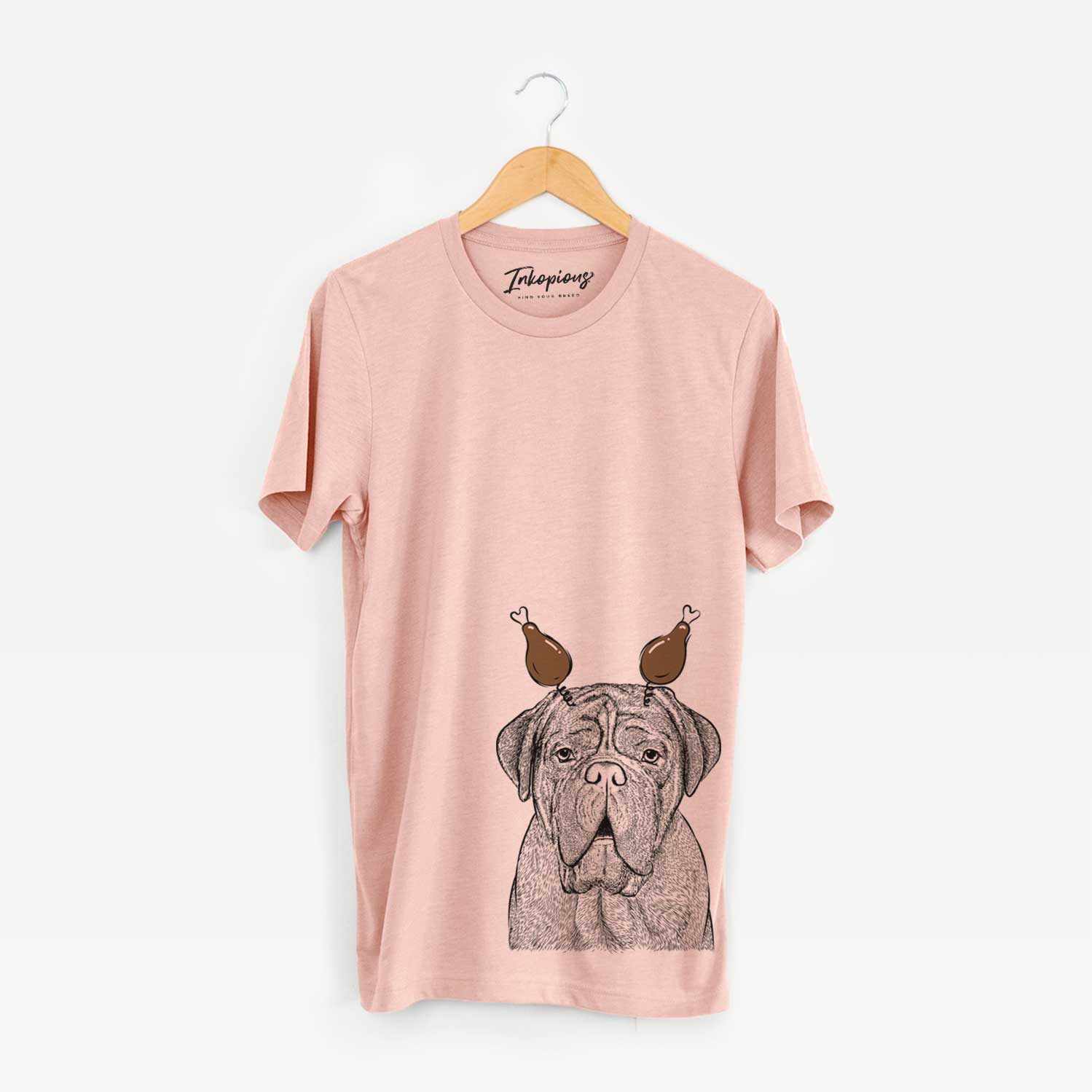Hand-drawn sketch of Optimus the Dogue de Bordeaux with a Thanksgiving turkey headpiece on a Peach Unisex crewneck