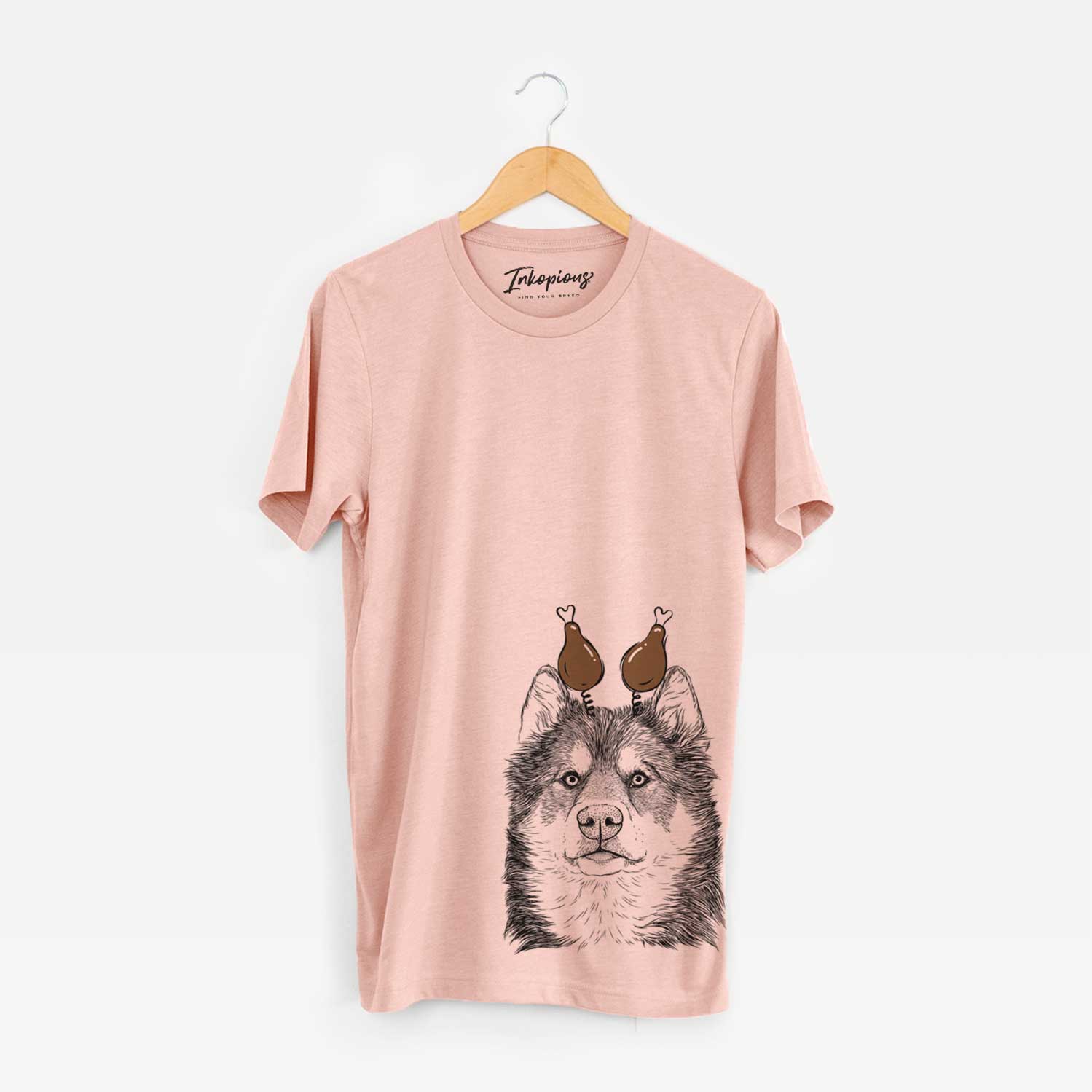 Hand-drawn sketch of Oskar the Canadian Eskimo Dog with a Thanksgiving turkey headpiece on a Peach Unisex crewneck