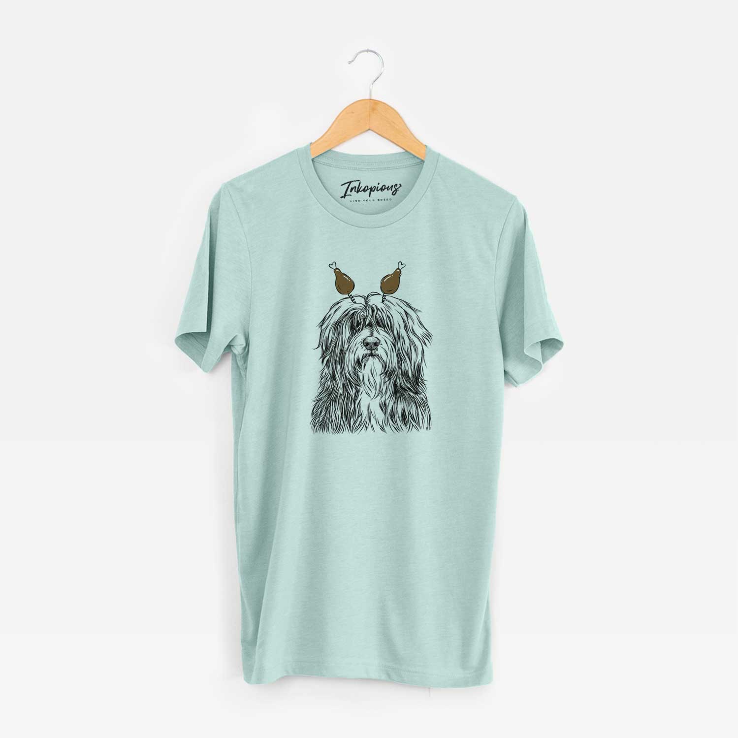 Hand-drawn sketch of Otto the Polish Lowland Sheepdog with a Thanksgiving turkey headpiece on a Heather Sage Unisex crewneck