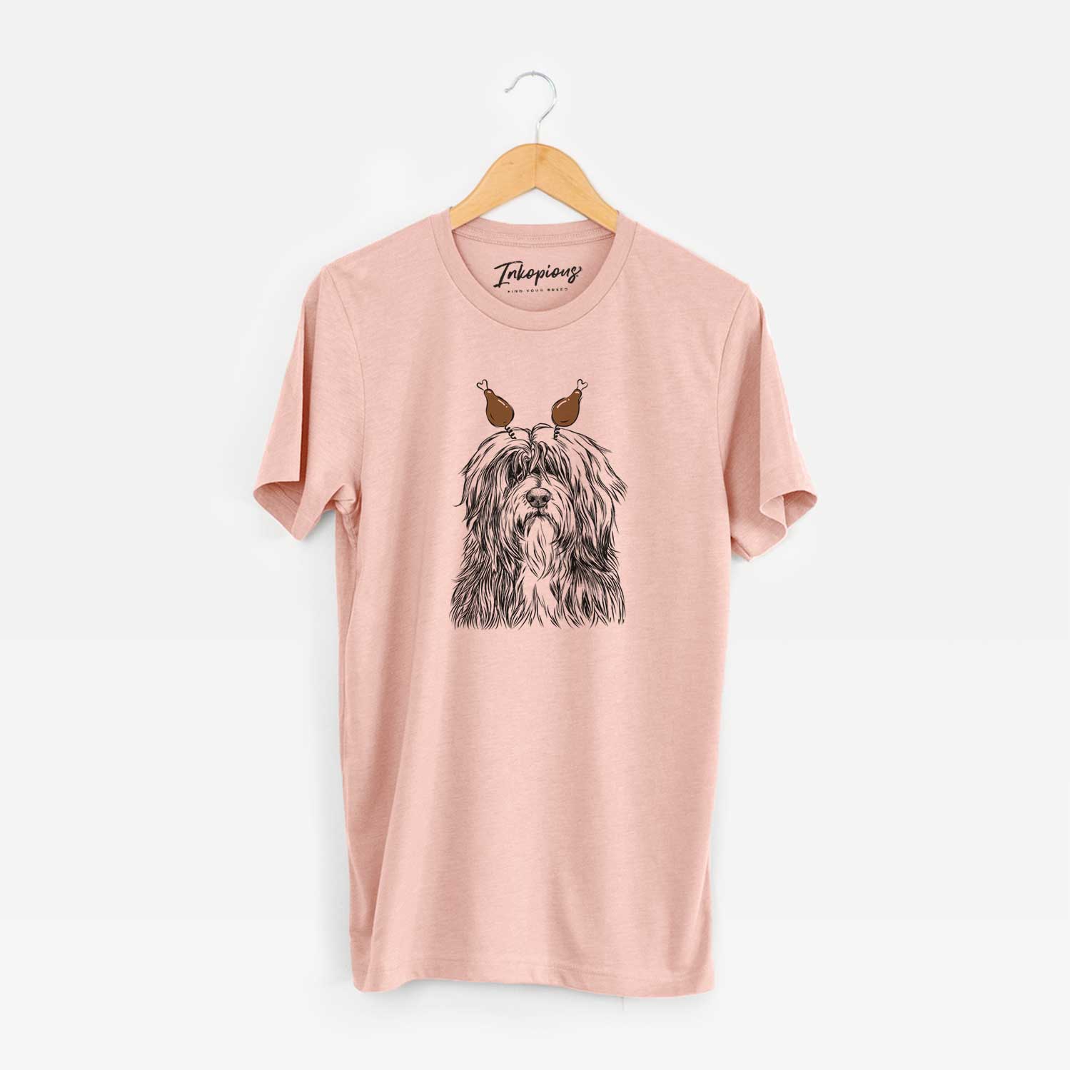 Hand-drawn sketch of Otto the Polish Lowland Sheepdog with a Thanksgiving turkey headpiece on a Peach Unisex crewneck