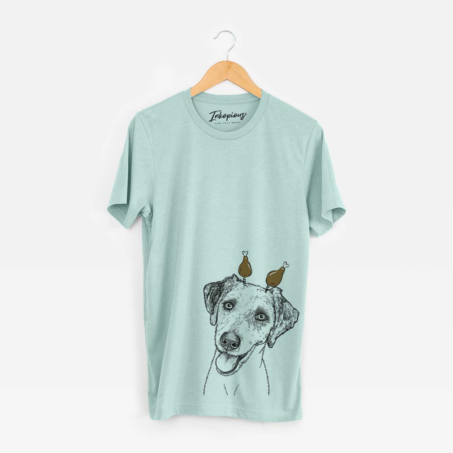 Hand-drawn sketch of Palm Palm the Aussiedoodle with a Thanksgiving turkey headpiece on a Heather Sage Unisex crewneck