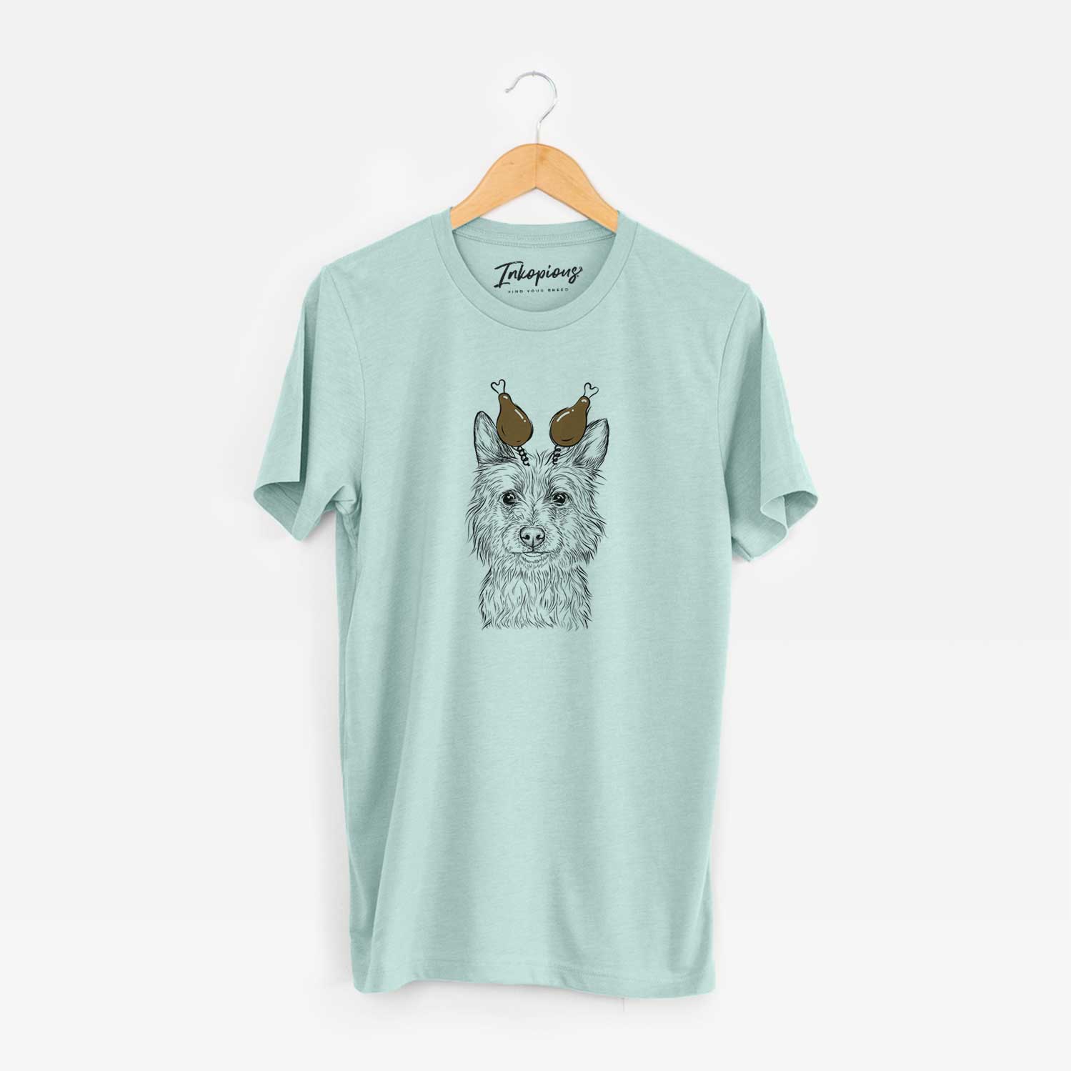 Hand-drawn sketch of Paulo the Portuguese Podengo with a Thanksgiving turkey headpiece on a Heather Sage Unisex crewneck