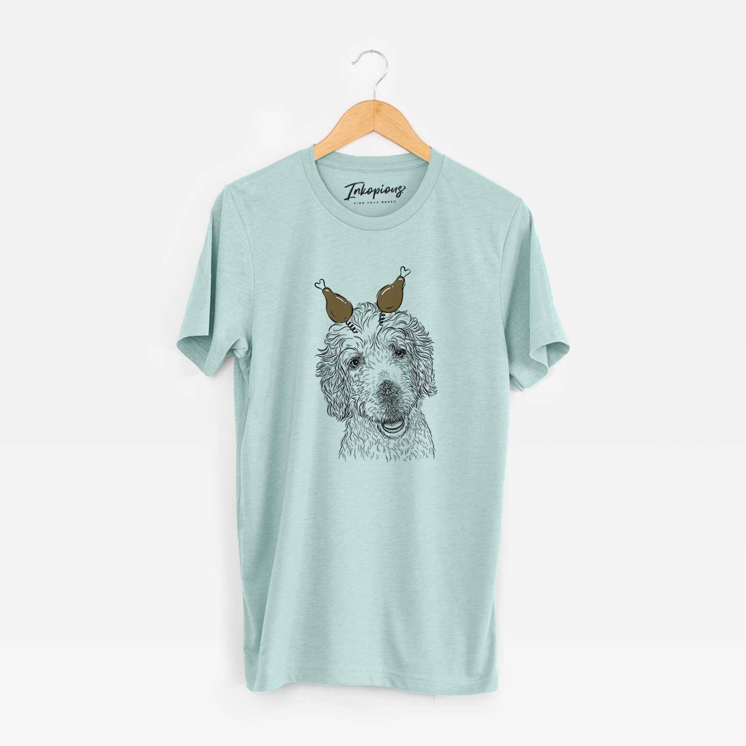 Hand-drawn sketch of Preston the Labradoodle with a Thanksgiving turkey headpiece on a Heather Sage Unisex crewneck