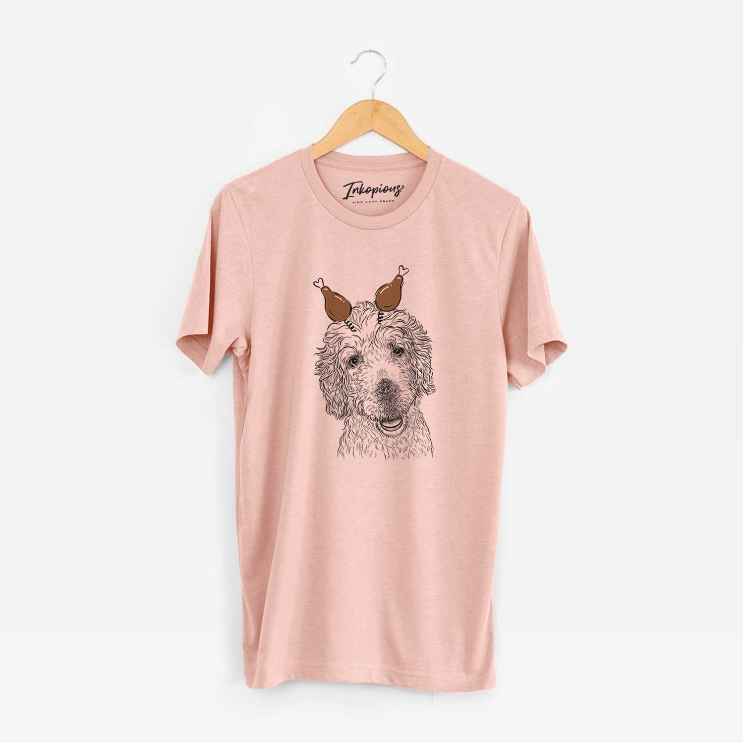 Hand-drawn sketch of Preston the Labradoodle with a Thanksgiving turkey headpiece on a Peach Unisex crewneck