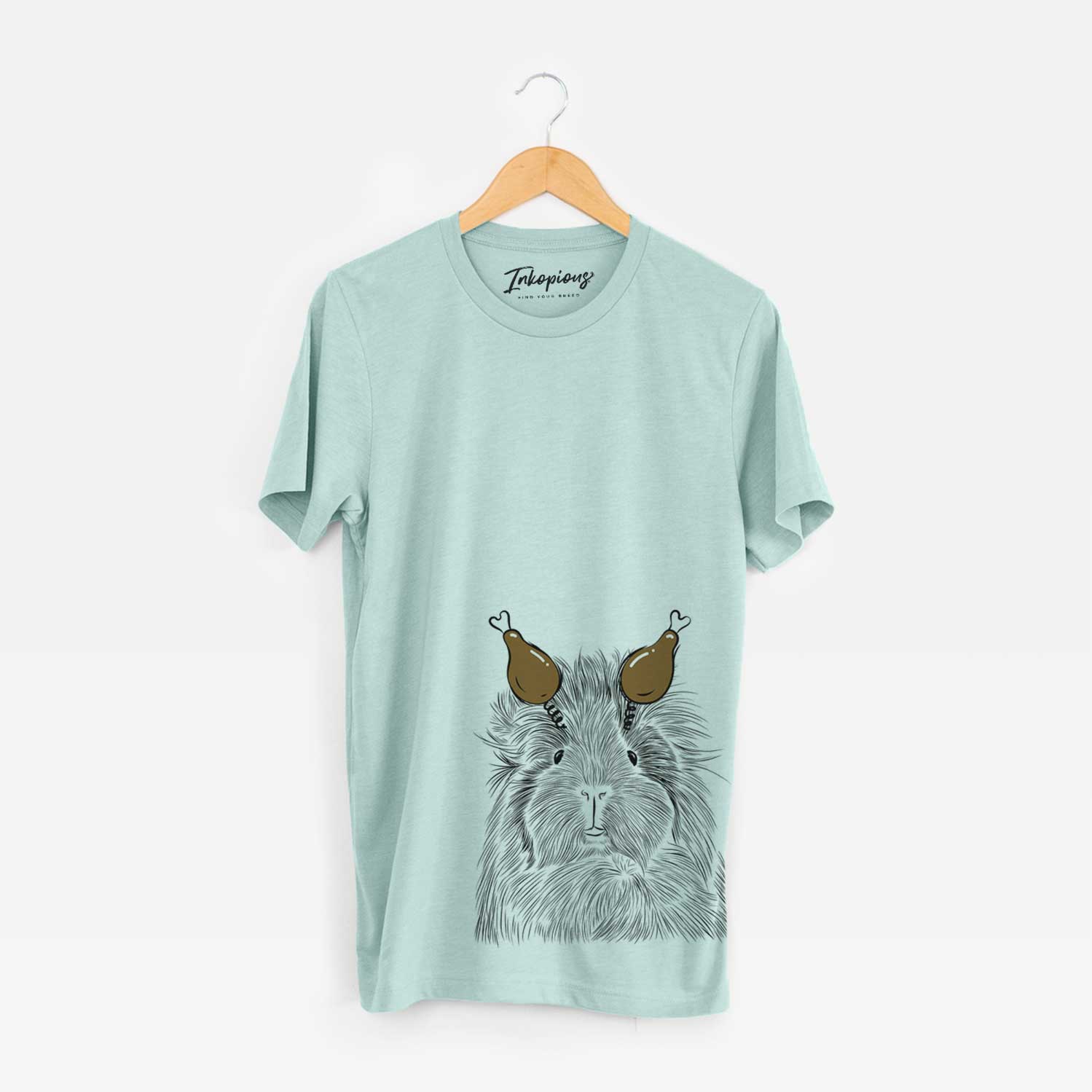Hand-drawn sketch of Rhino the Guinea Pig with a Thanksgiving turkey headpiece on a Heather Sage Unisex crewneck