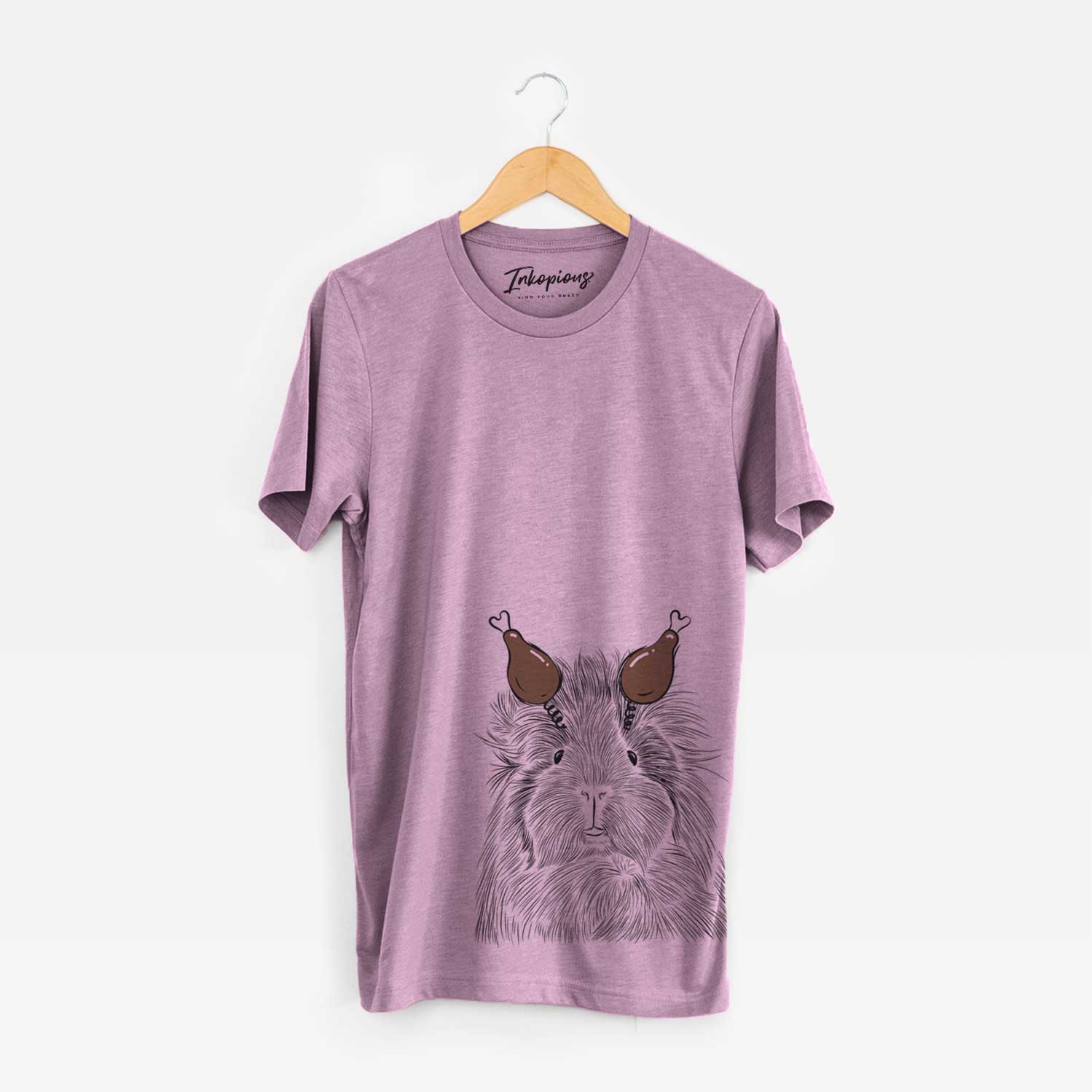Hand-drawn sketch of Rhino the Guinea Pig with a Thanksgiving turkey headpiece on an Orchid Unisex crewneck