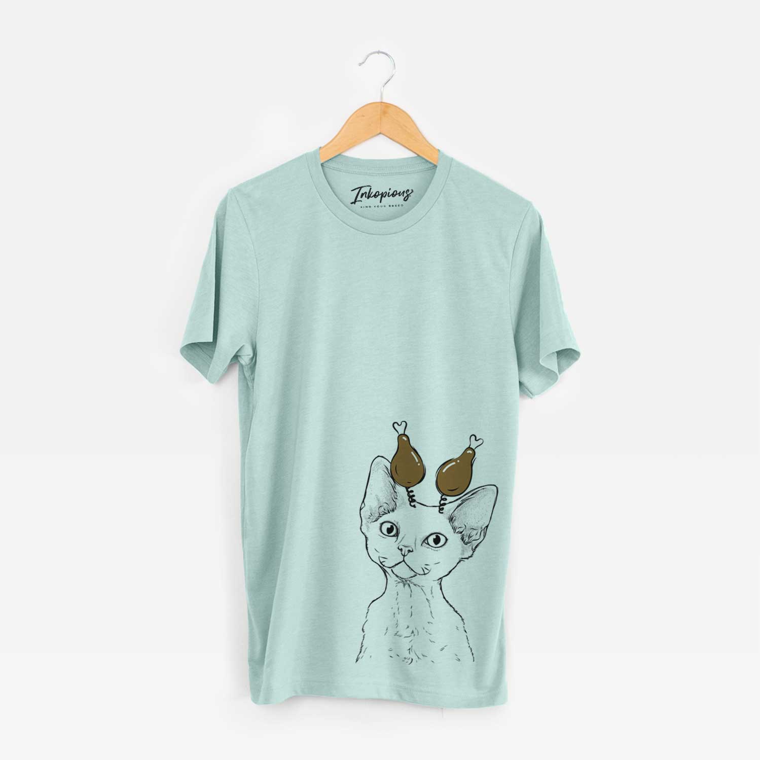 Hand-drawn sketch of Ripley the Devon Rex Cat with a Thanksgiving turkey headpiece on a Heather Sage Unisex crewneck