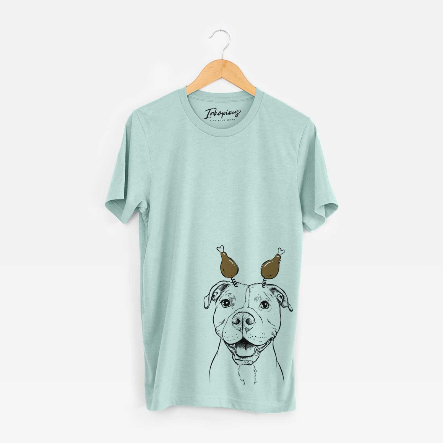 Hand-drawn sketch of Roscoe the Pitbull with a Thanksgiving turkey headpiece on a Heather Sage Unisex crewneck