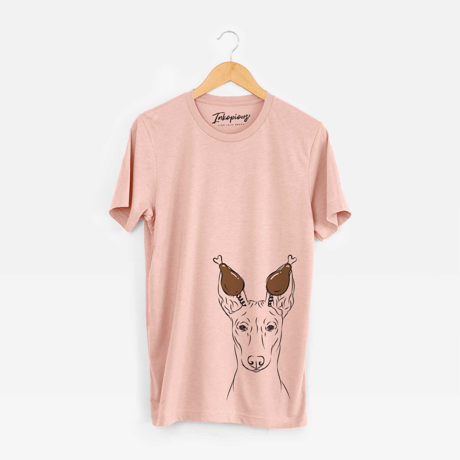 Hand-drawn sketch of Ruadh the Pharaoh Hound with a Thanksgiving turkey headpiece on a Peach Unisex crewneck