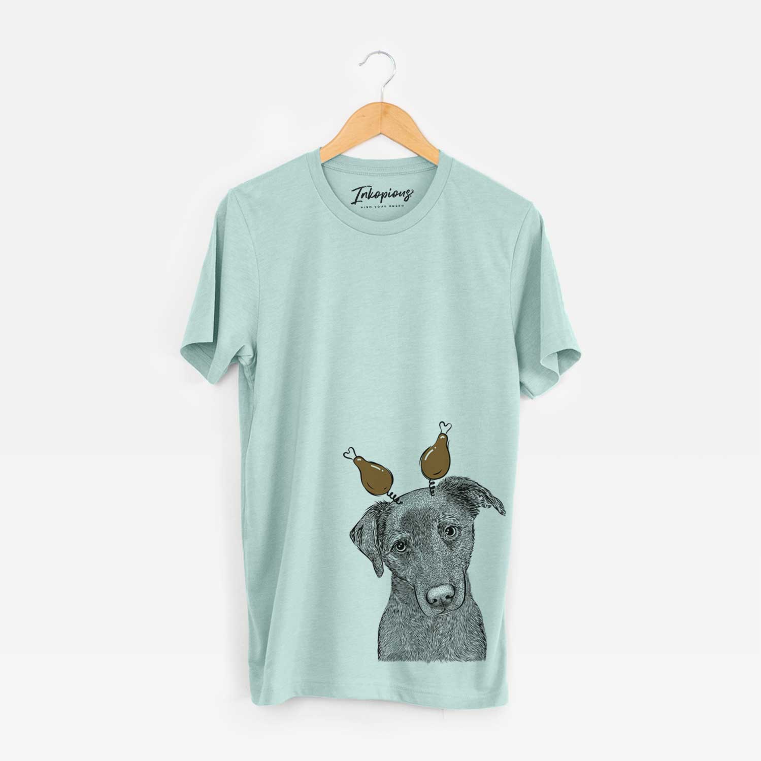 Hand-drawn sketch of Sadie the Whipador with a Thanksgiving turkey headpiece on a Heather Sage Unisex crewneck
