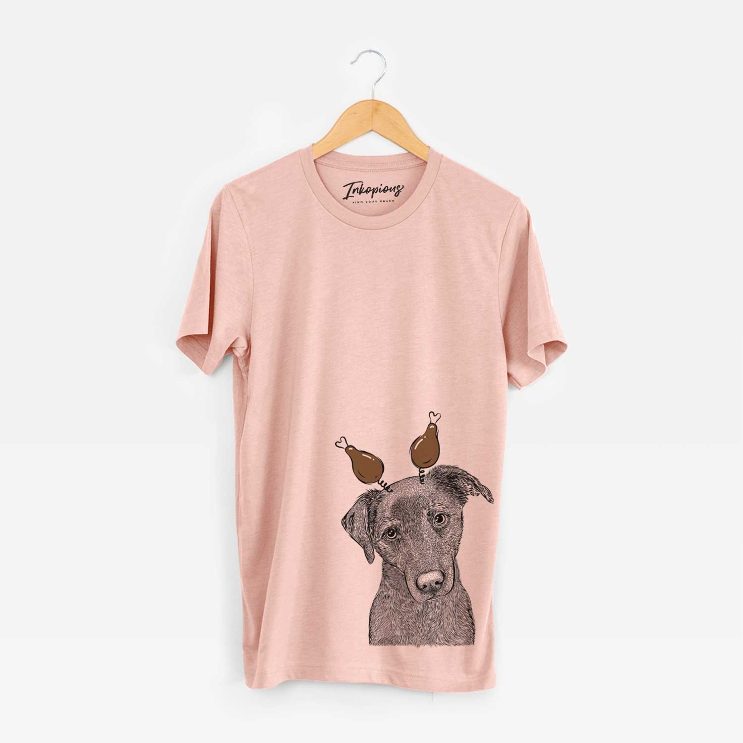 Hand-drawn sketch of Sadie the Whipador with a Thanksgiving turkey headpiece on a Peach Unisex crewneck