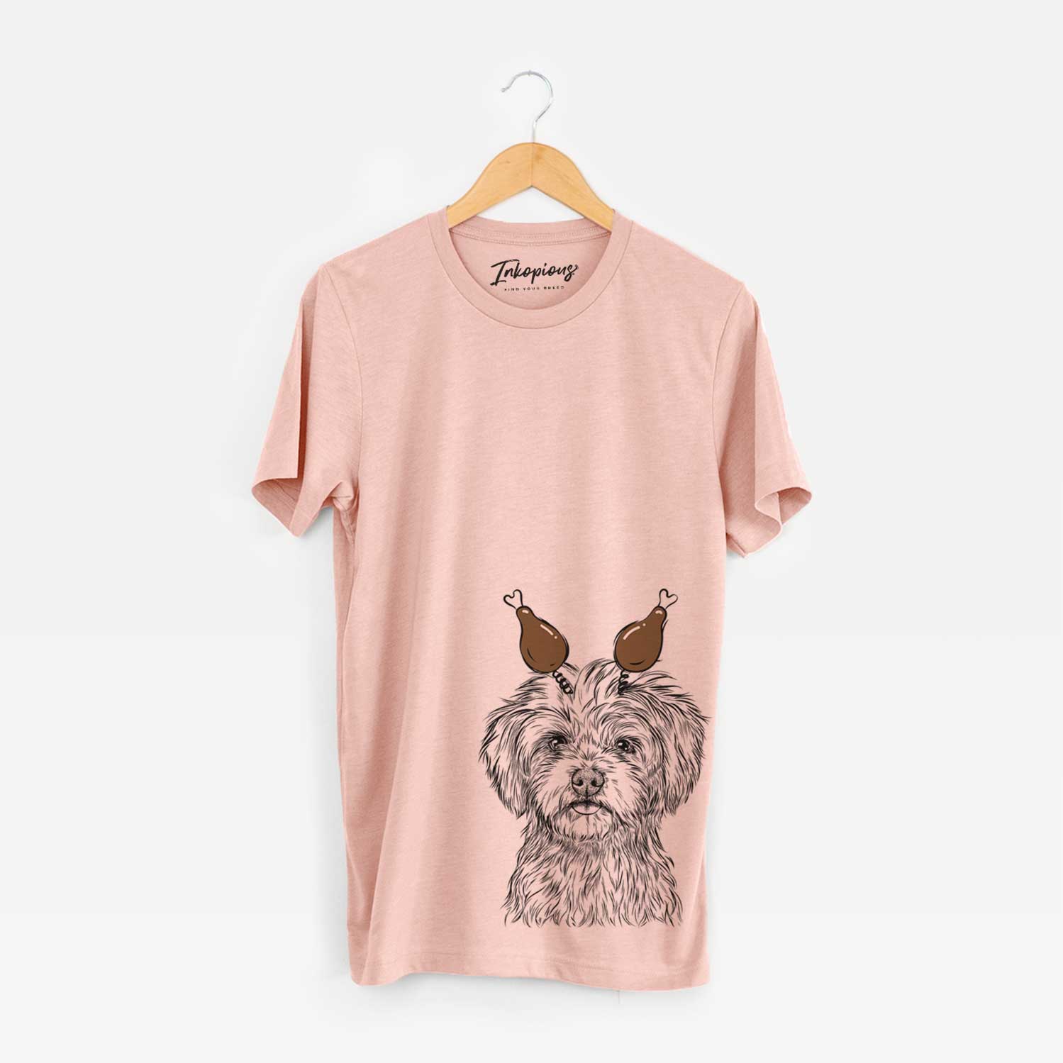 Hand-drawn sketch of Sammy the Shorkie with a Thanksgiving turkey headpiece on a Peach Unisex crewneck