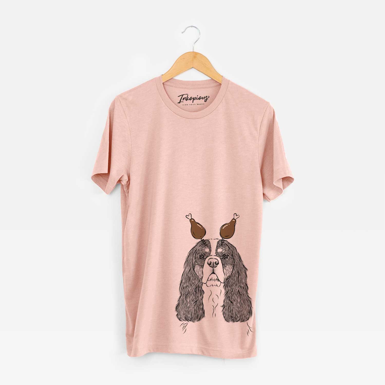 Hand-drawn sketch of Sebastian the Cavalier King Charles Spaniel with a Thanksgiving turkey headpiece on a Peach Unisex crewneck