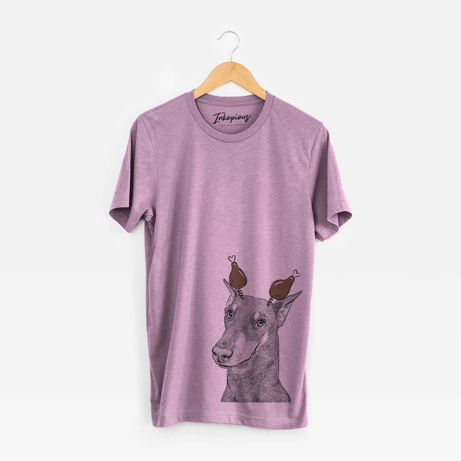 Hand-drawn sketch of Shelby the Doberman Pinscher with a Thanksgiving turkey headpiece on an Orchid Unisex crewneck