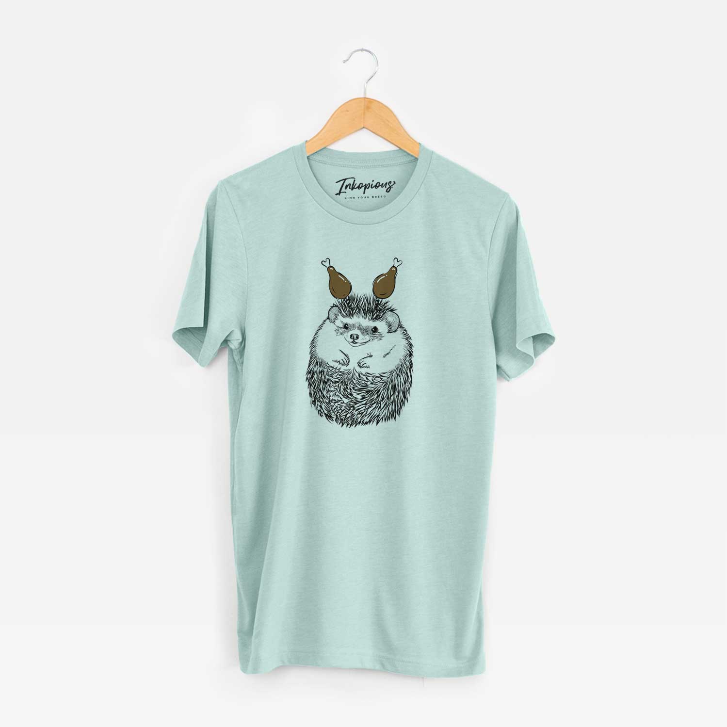 Hand-drawn sketch of Sid the Hedgehog with a Thanksgiving turkey headpiece on a Heather Sage Unisex crewneck