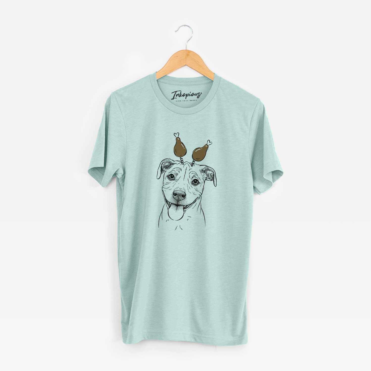 Hand-drawn sketch of Skye the Pitweiler with a Thanksgiving turkey headpiece on a Heather Sage Unisex crewneck