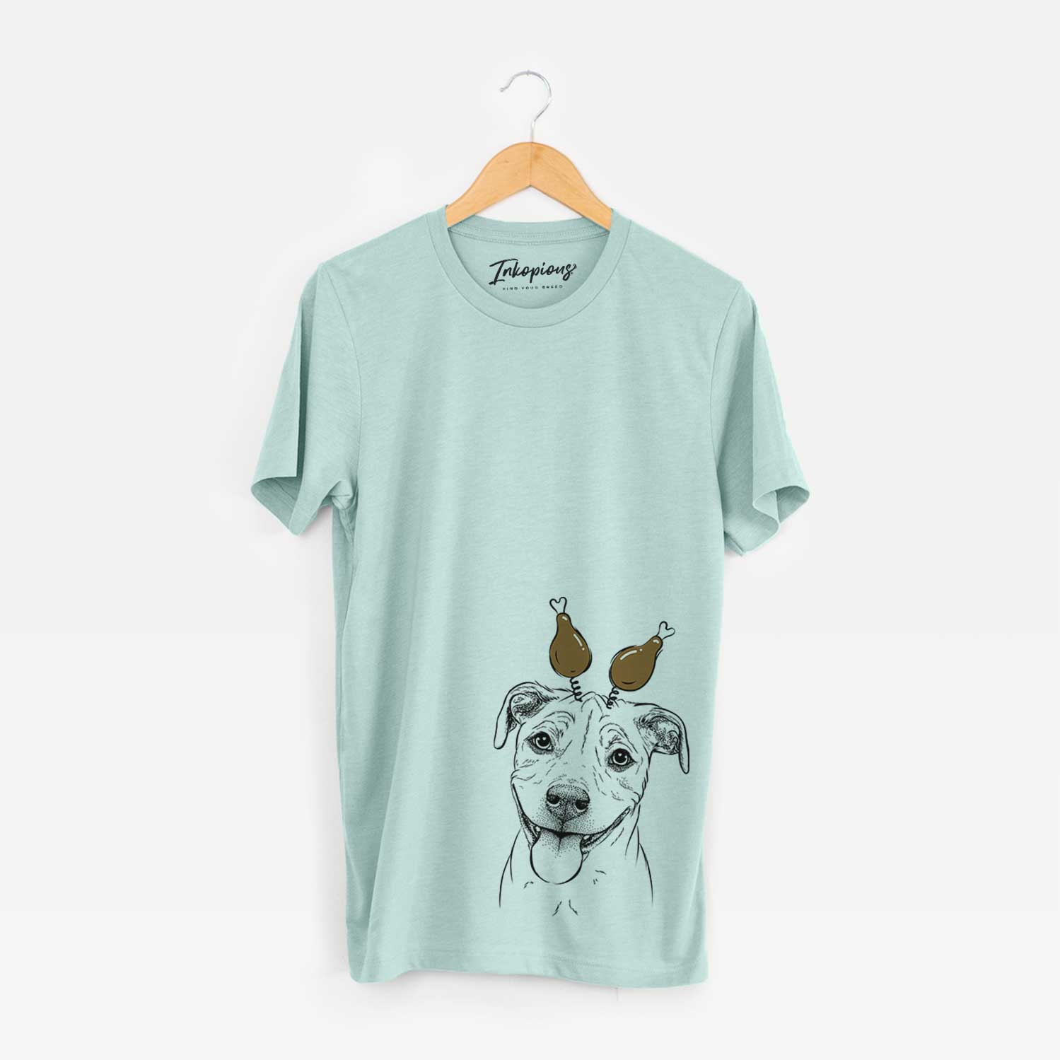 Hand-drawn sketch of Skye the Pitweiler with a Thanksgiving turkey headpiece on a Heather Sage Unisex crewneck