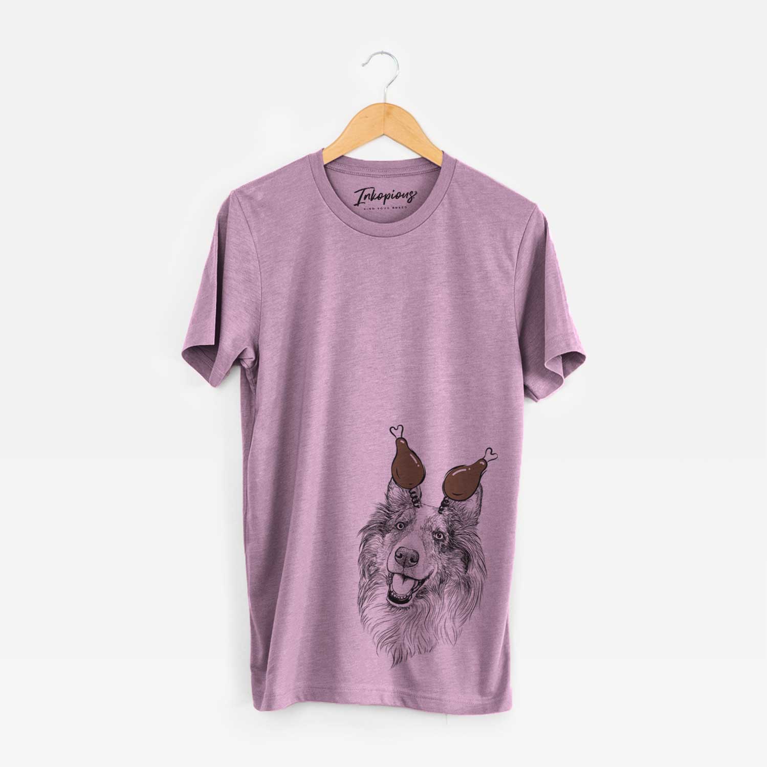 Hand-drawn sketch of Skylar the Shetland Sheepdog with a Thanksgiving turkey headpiece on an Orchid Unisex crewneck