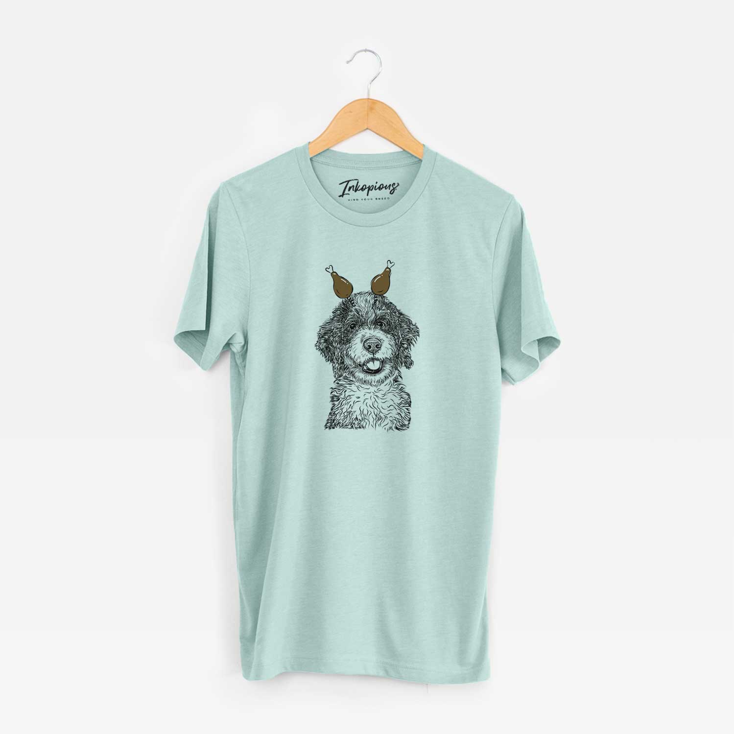 Hand-drawn sketch of Smoky the Bernedoodle Puppy with a Thanksgiving turkey headpiece on a Heather Sage Unisex crewneck