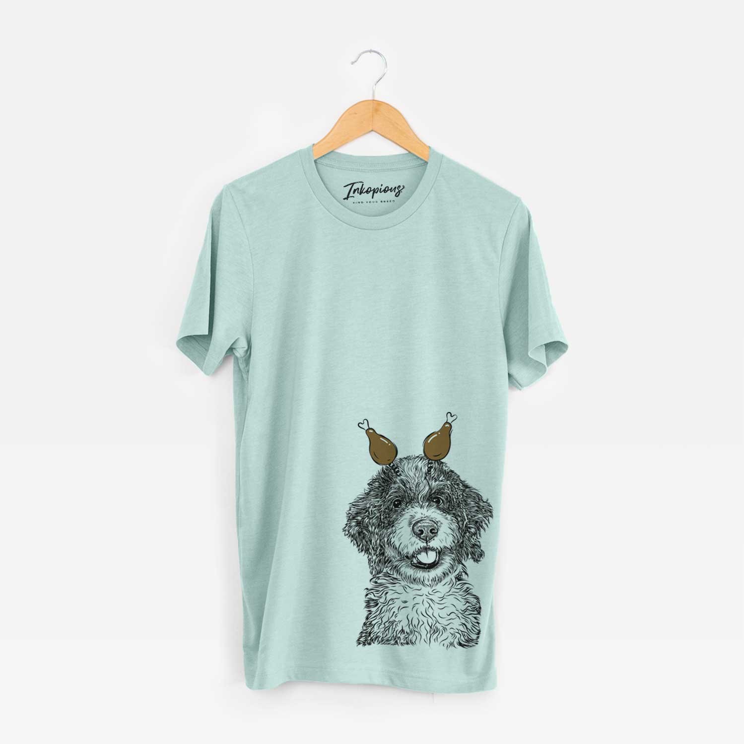 Hand-drawn sketch of Smoky the Bernedoodle Puppy with a Thanksgiving turkey headpiece on a Heather Sage Unisex crewneck