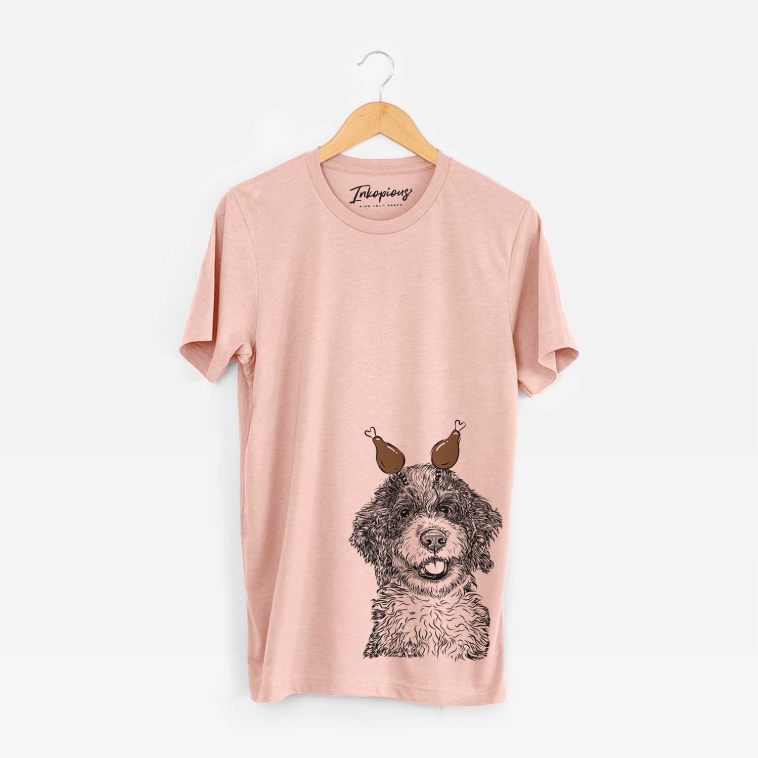 Hand-drawn sketch of Smoky the Bernedoodle Puppy with a Thanksgiving turkey headpiece on a Peach Unisex crewneck