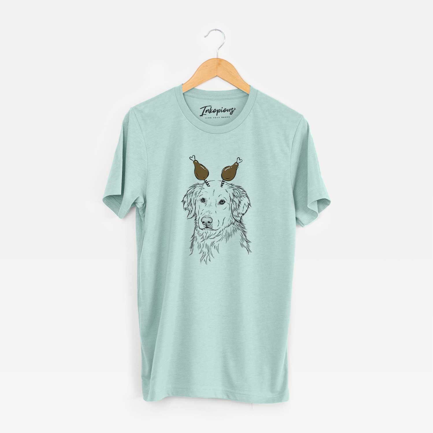 Hand-drawn sketch of Spencer the Golden Retriever with a Thanksgiving turkey headpiece on a Heather Sage Unisex crewneck