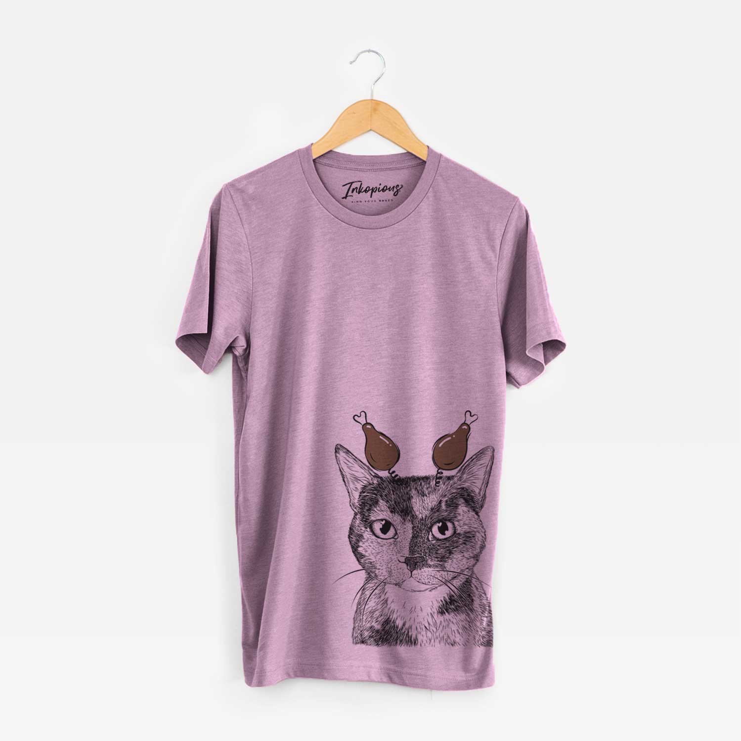 Hand-drawn sketch of Spooky Kitty the Tortoiseshell Cat with a Thanksgiving turkey headpiece on an Orchid Unisex crewneck