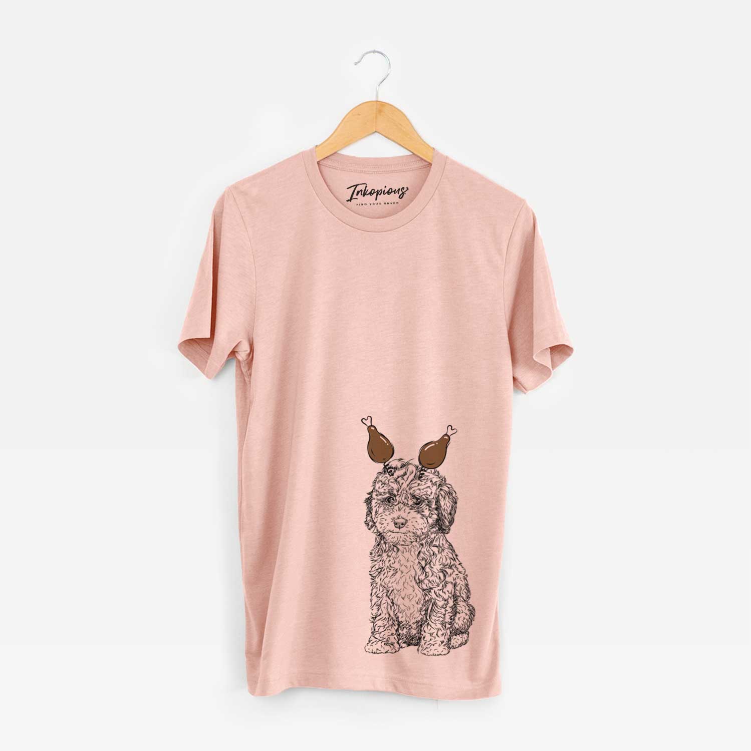 Hand-drawn sketch of Sweet Tea the Mini Doodle with a Thanksgiving turkey headpiece on a Peach Unisex crewneck
