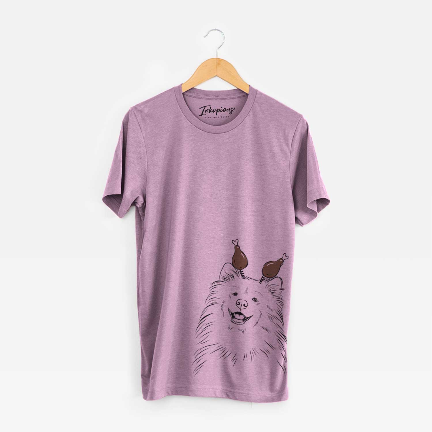 Hand-drawn sketch of Tillie the Samoyed with a Thanksgiving turkey headpiece on an Orchid Unisex crewneck