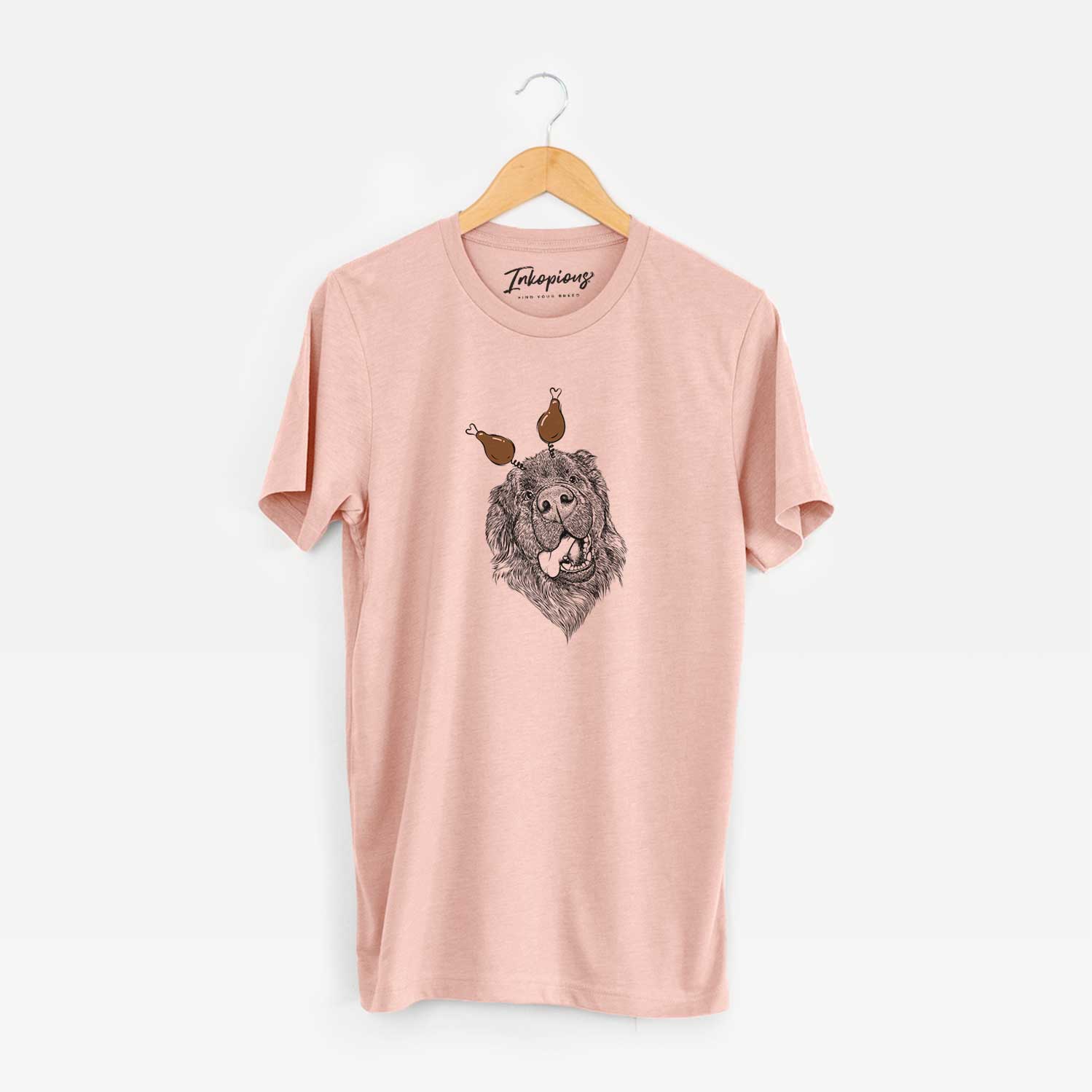 Hand-drawn sketch of Tuna the Newfoundland with a Thanksgiving turkey headpiece on a Peach Unisex crewneck