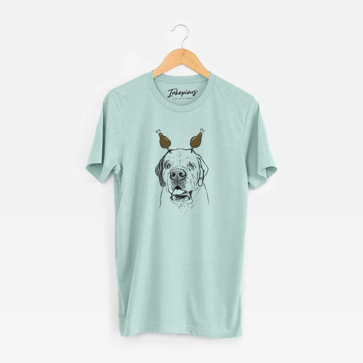Hand-drawn sketch of Wendy the Saint Bernard with a Thanksgiving turkey headpiece on a Heather Sage Unisex crewneck