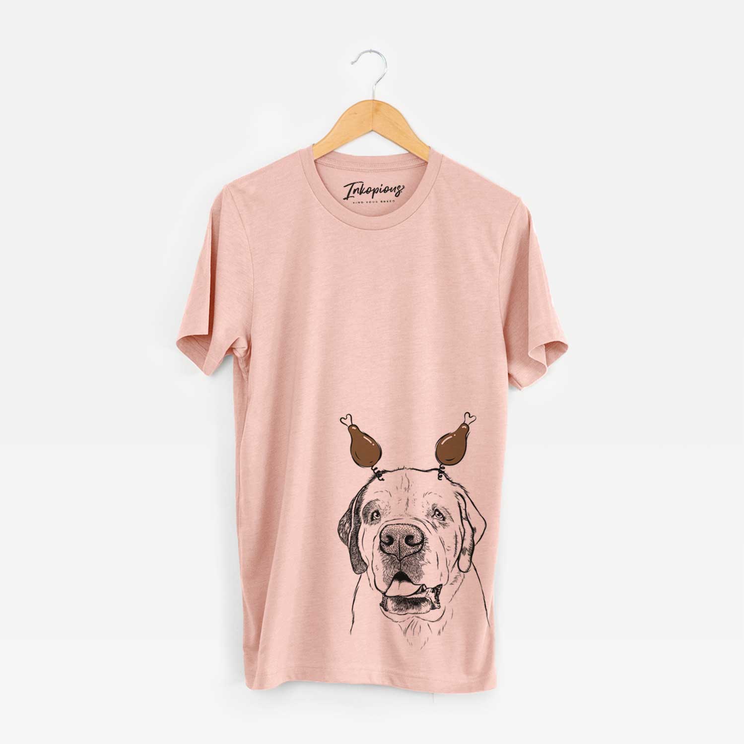 Hand-drawn sketch of Wendy the Saint Bernard with a Thanksgiving turkey headpiece on a Peach Unisex crewneck
