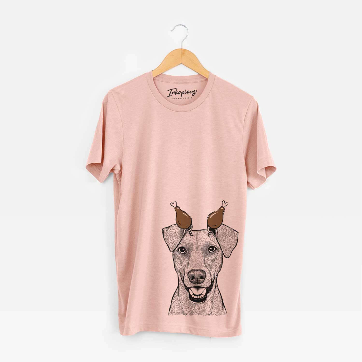 Hand-drawn sketch of Willow the German Pinscher with a Thanksgiving turkey headpiece on a Peach Unisex crewneck