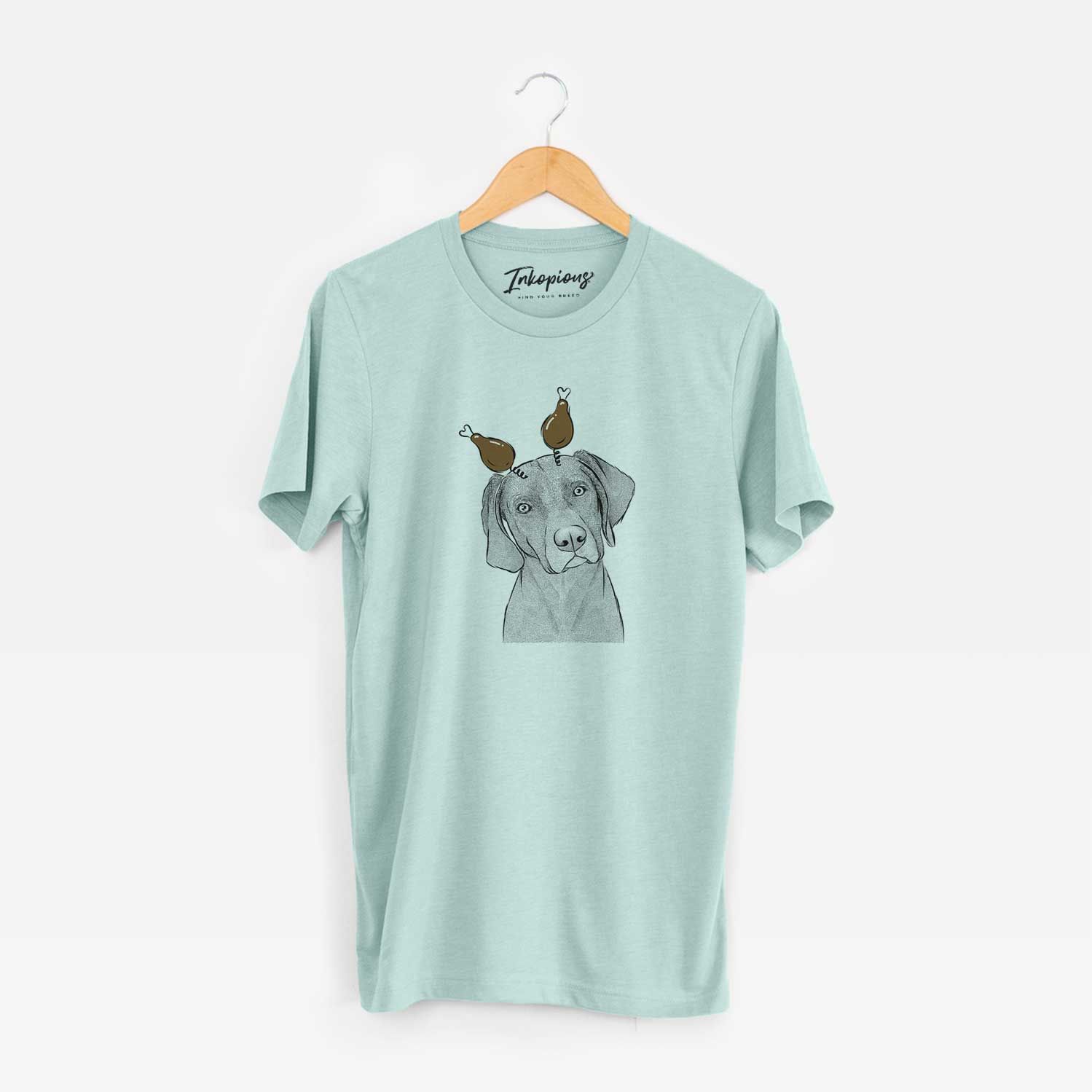 Hand-drawn sketch of Willow the Weizsla with a Thanksgiving turkey headpiece on a Heather Sage Unisex crewneck