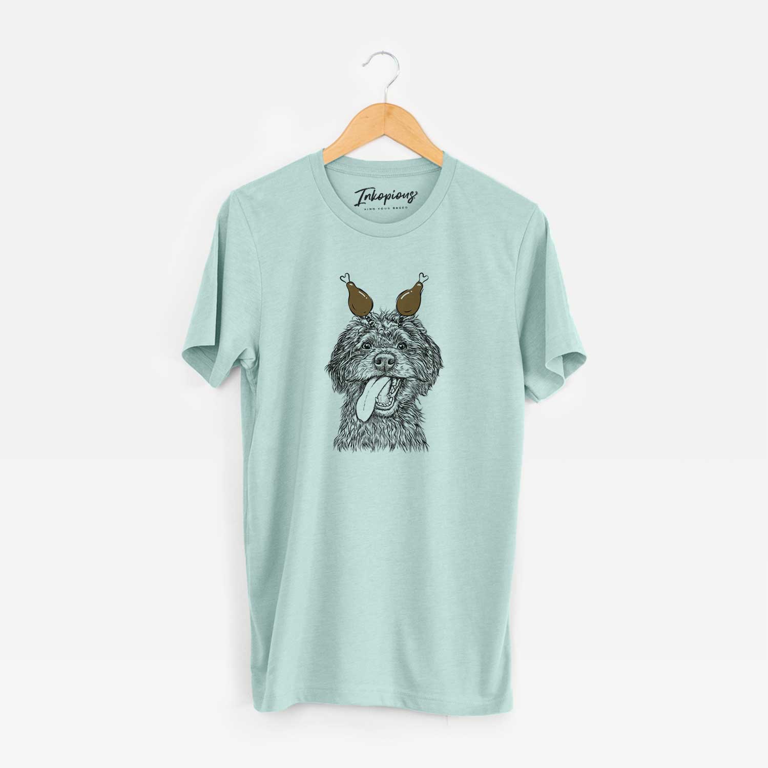 Hand-drawn sketch of Winnie the Mini Aussiedoodle with a Thanksgiving turkey headpiece on a Heather Sage Unisex crewneck